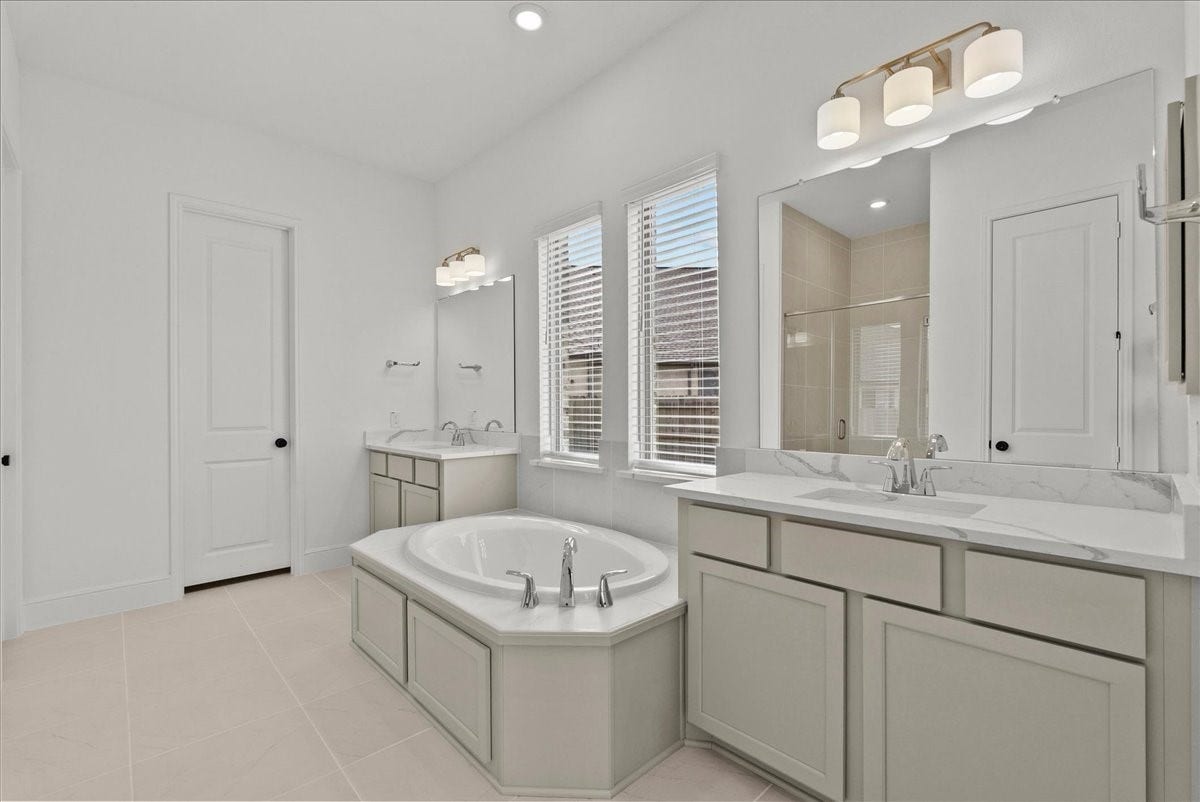 3013 Shelly Bayou Court, League City, TX 77573 Spa-like en-suite bath with dual vanities, a walk-in shower, soaking tub, and large walk-in closet