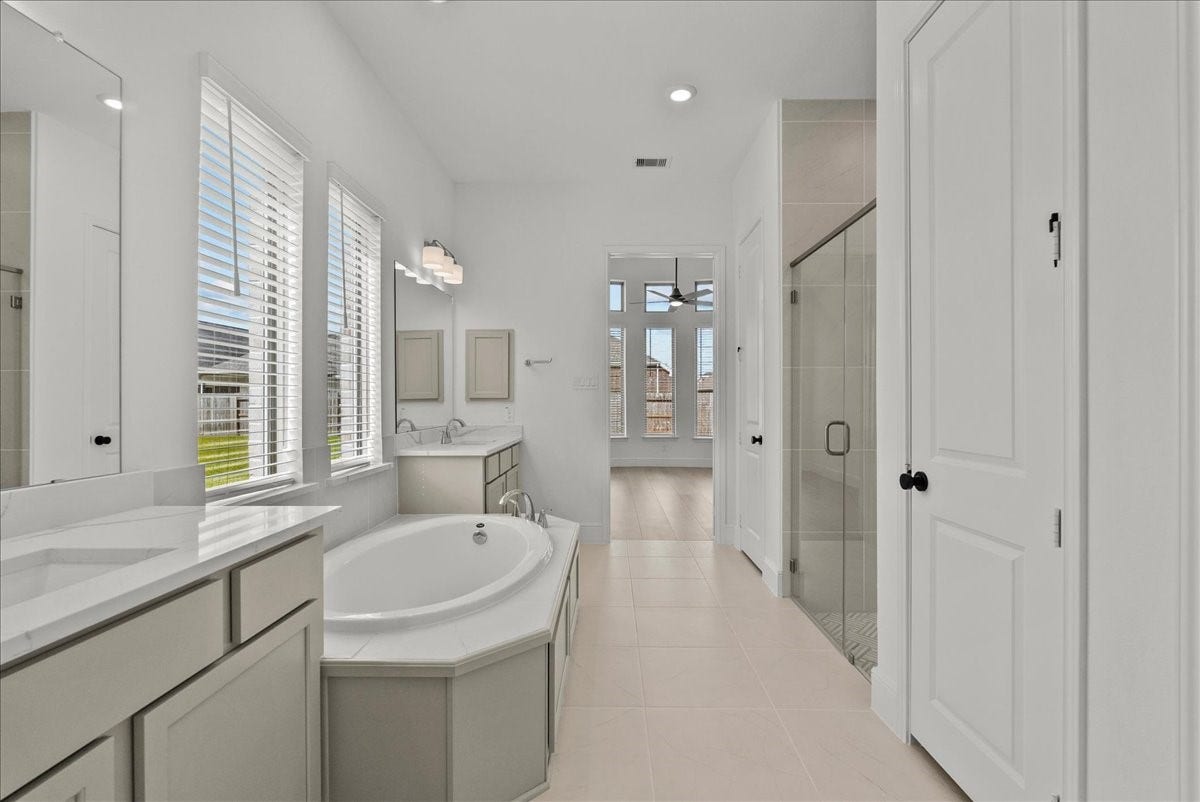 3013 Shelly Bayou Court, League City, TX 77573 Spa-like en-suite bath with dual vanities, a walk-in shower, soaking tub, and large walk-in closet