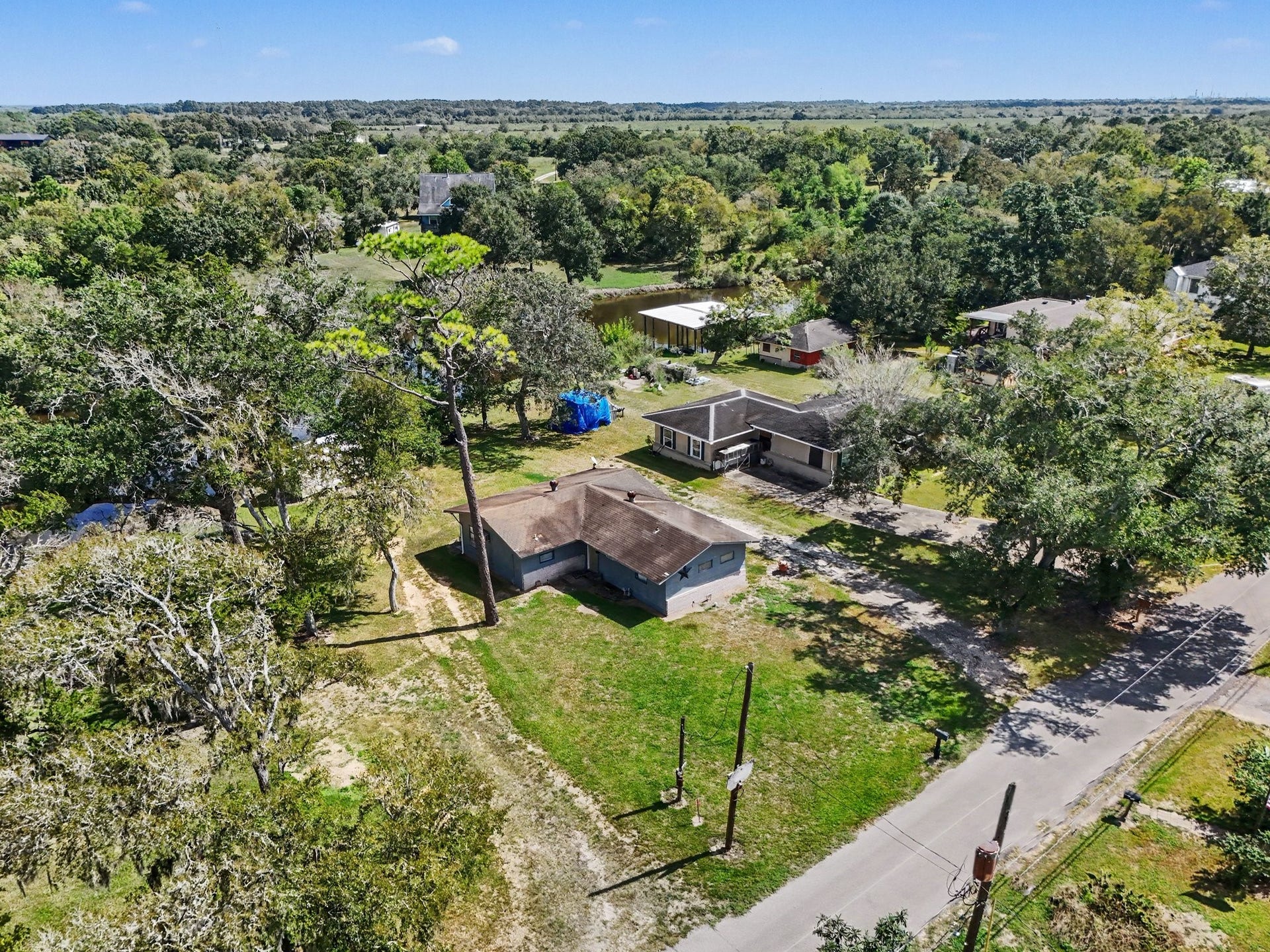 3315 Saint Anne Street, Liverpool, TX 77577 Charming property nestled among lush greenery, offering a peaceful setting with ample outdoor space and mature trees, perfect for privacy and tranquility.