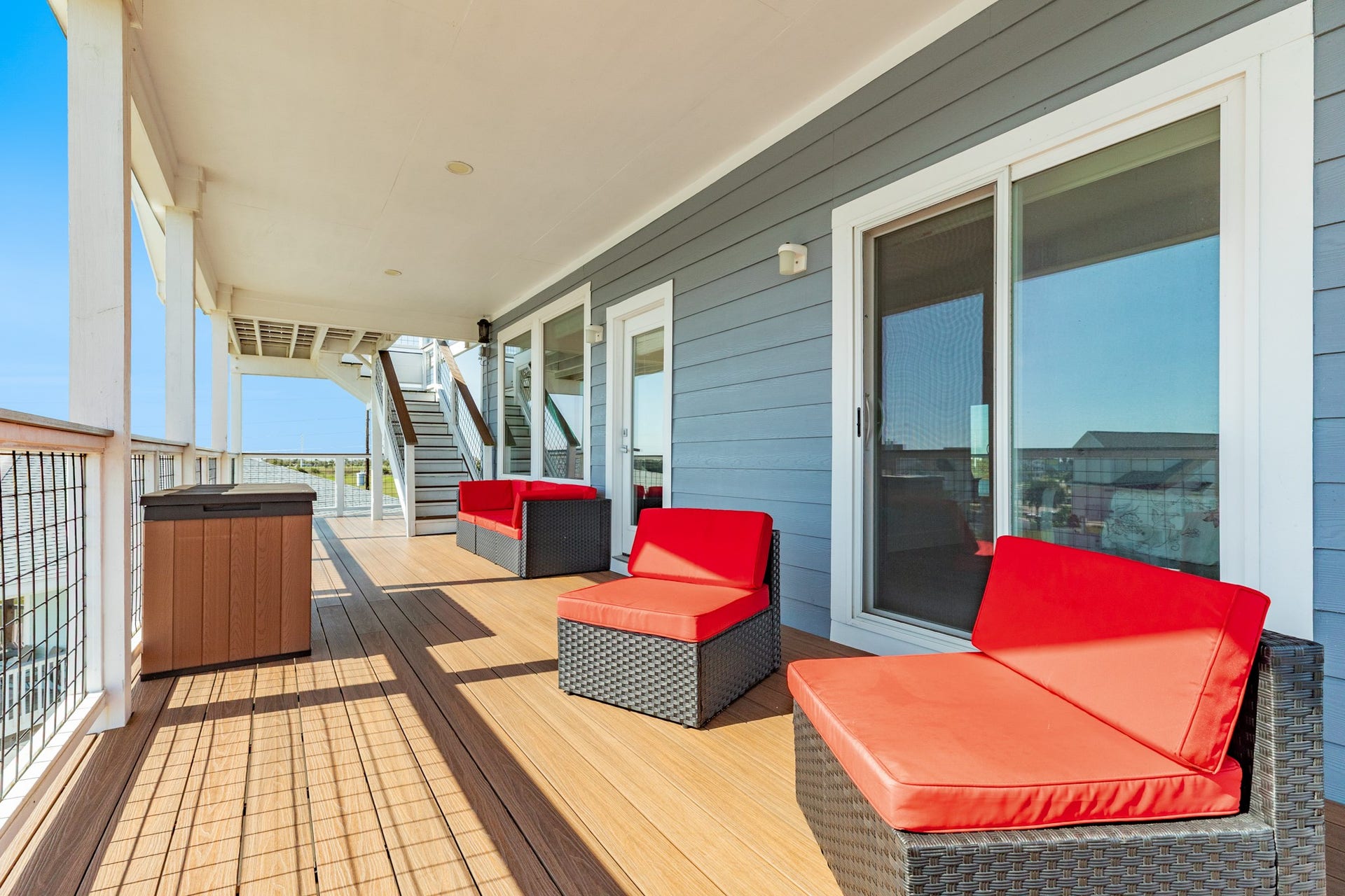 3903 Pirates Beach Blvd Court, Galveston, TX 77554 South facing 2nd level covered deck area with staircase leading up to observation platform. Deck access is from the family room or primary bedroom.