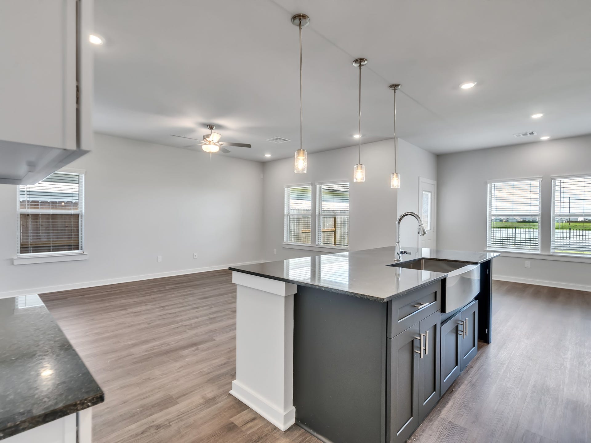 1206 Elsinore Drive, Rosharon, TX 77583 The kitchen offers views of the waterfront and multiple adjoining rooms, creating an open and connected living experience.