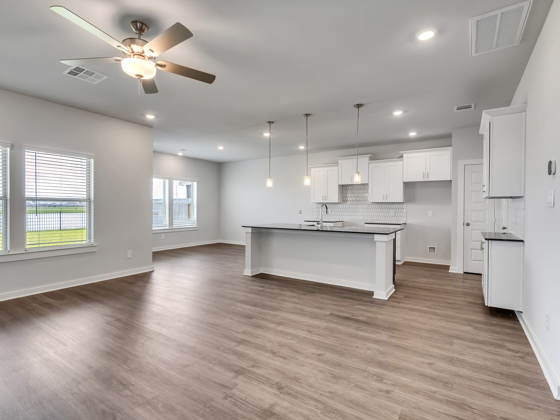 1206 Elsinore Drive, Rosharon, TX 77583 Large windows along the back of the home showcase waterfront views while allowing natural light to fill the space.
