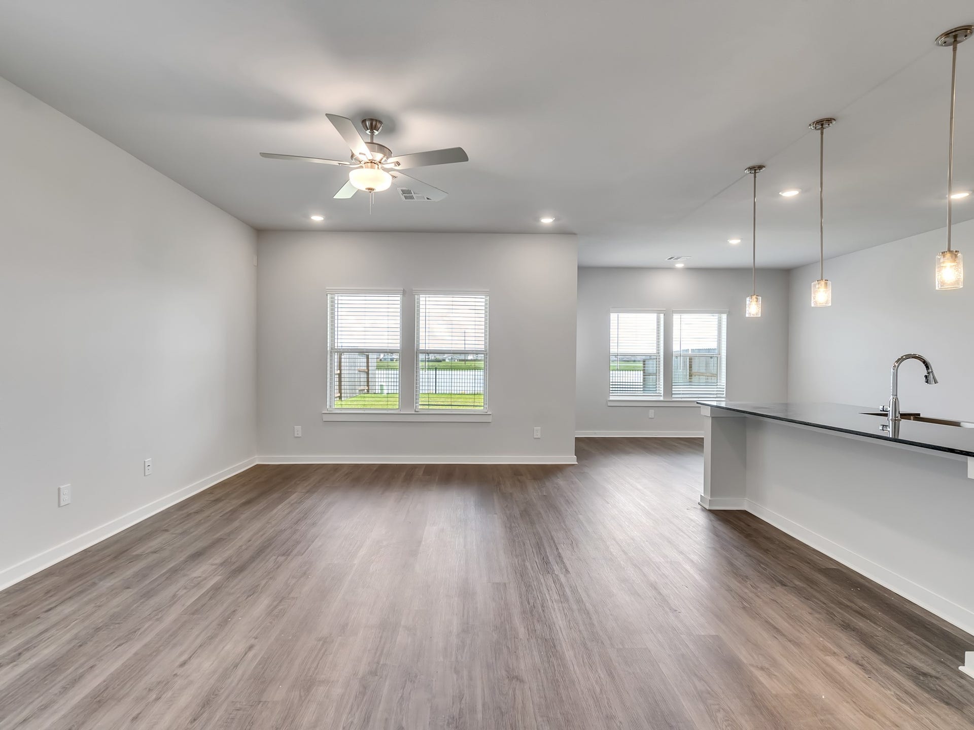 1206 Elsinore Drive, Rosharon, TX 77583 The thoughtfully designed open-concept floor plan features recessed LED lighting, neutral-toned finishes, and easy-to-maintain luxury vinyl plank (LVP) flooring throughout.