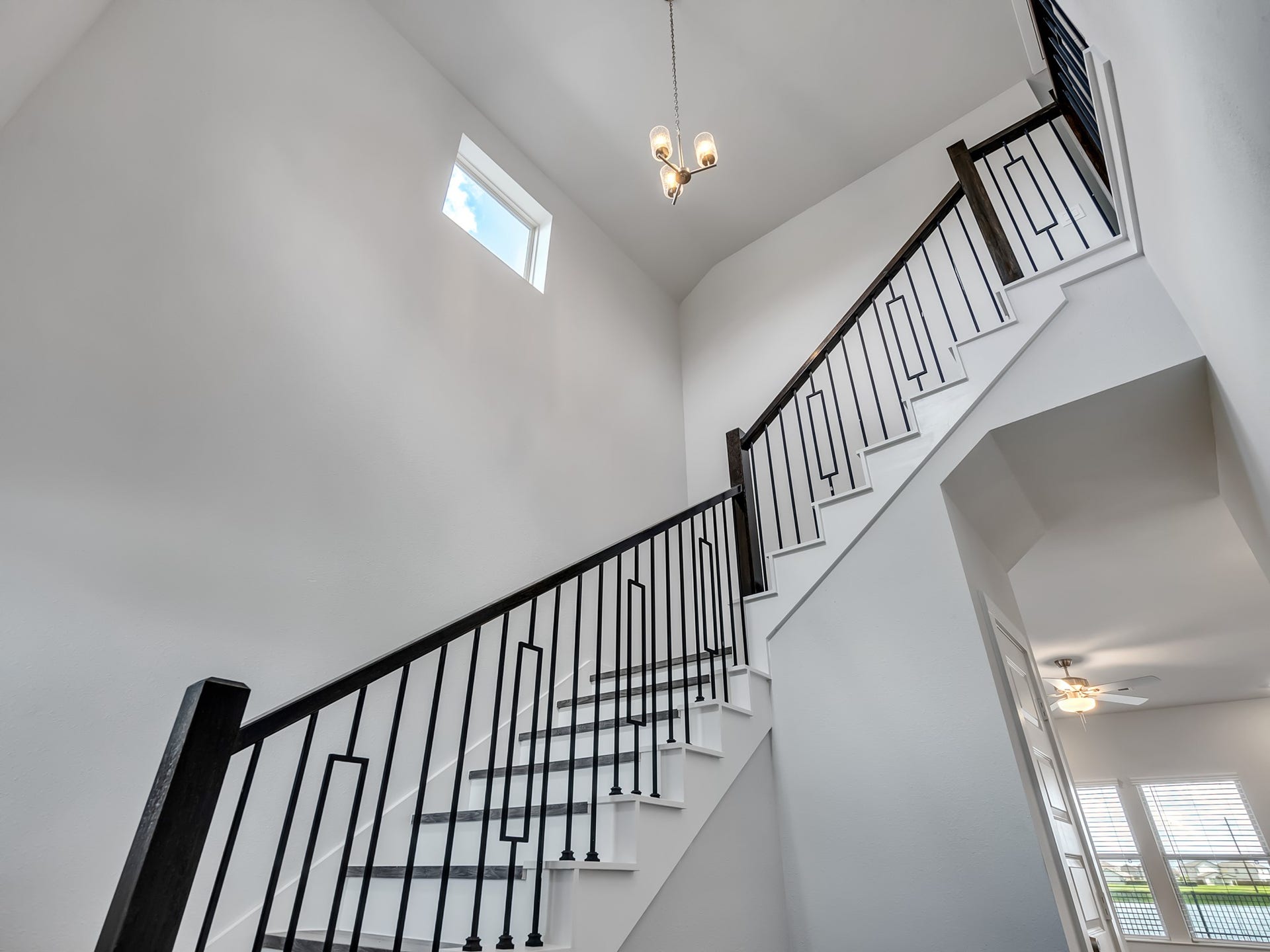 1206 Elsinore Drive, Rosharon, TX 77583 A soaring two-story entry, accented by a clerestory window and a dramatic staircase, creates a striking first impression.