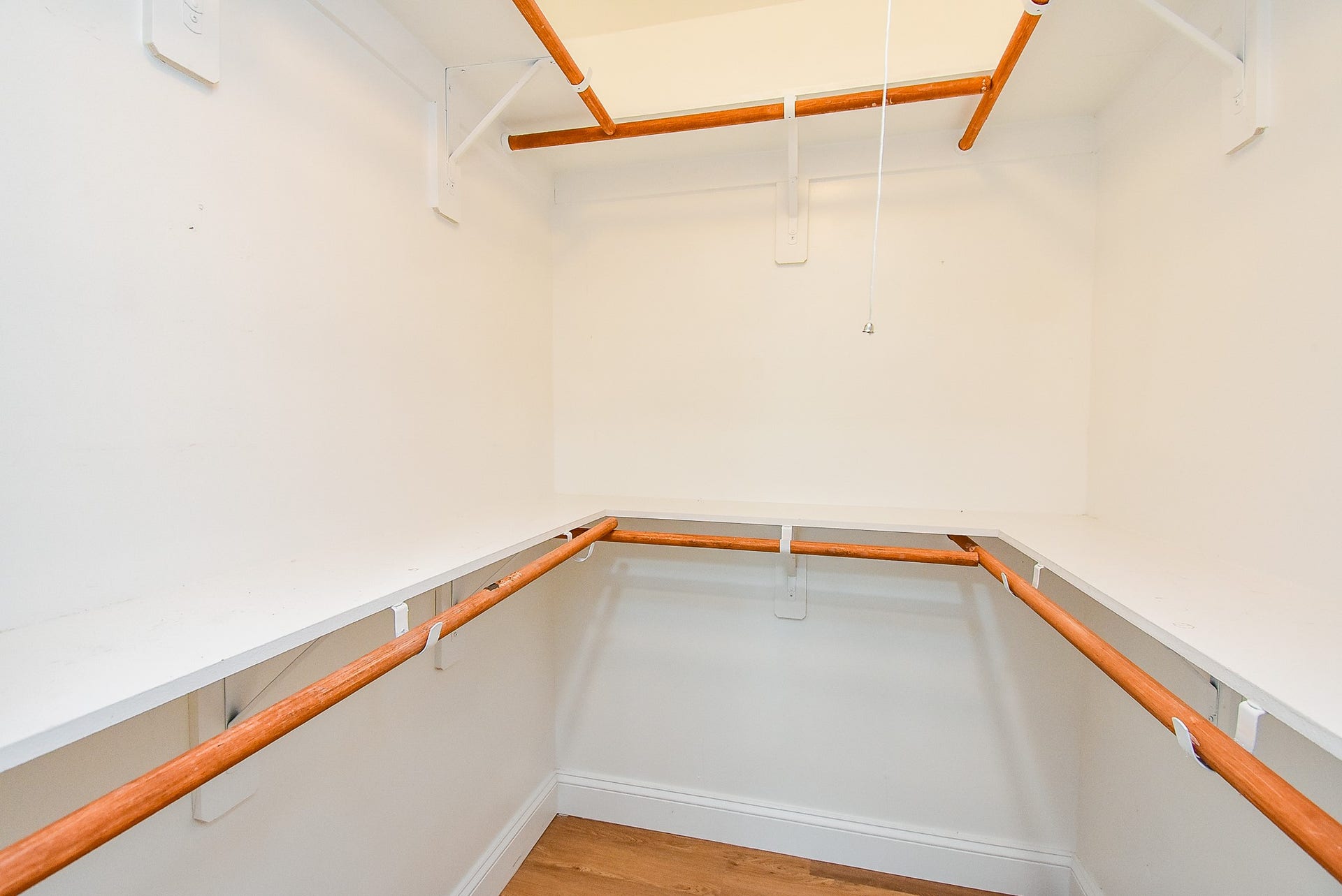 Spacious walk-in closet with ample hanging space and shelving.