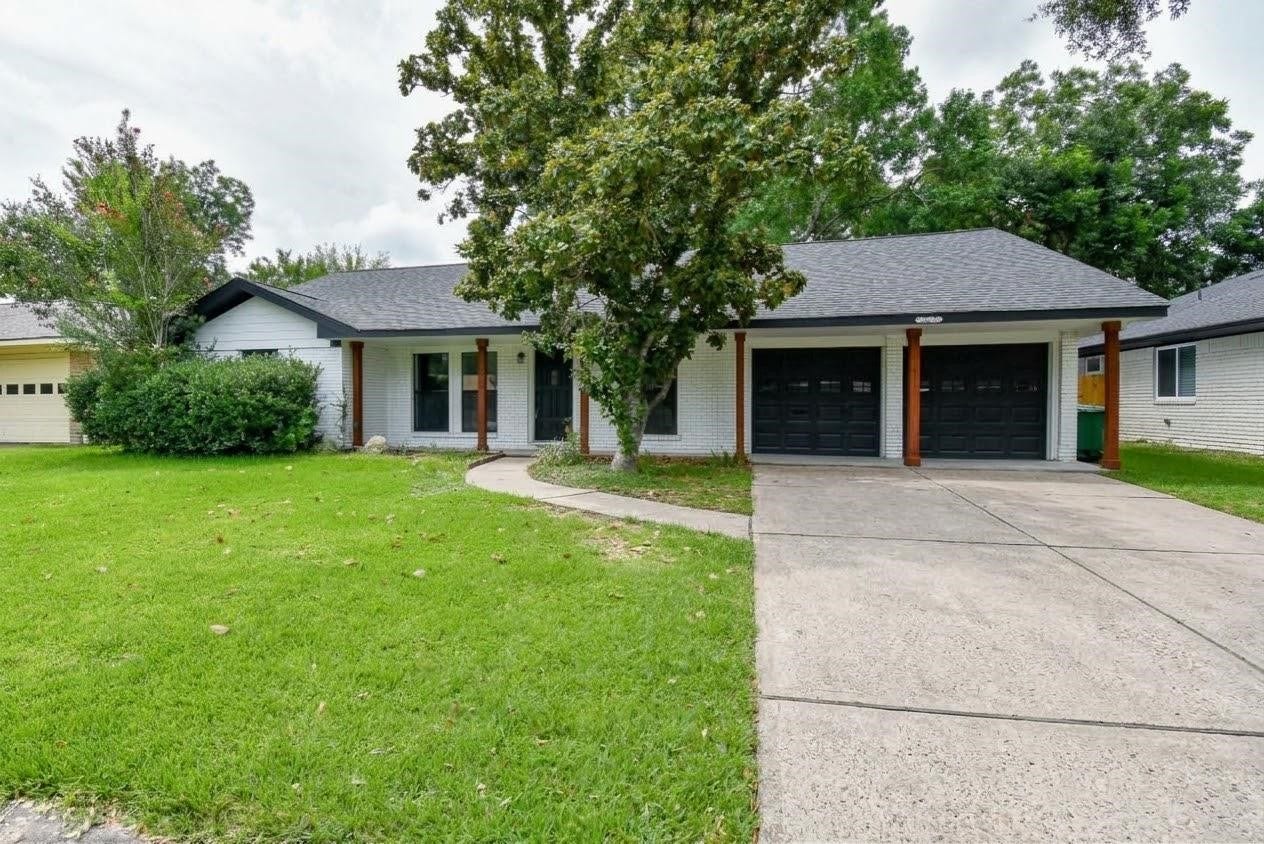 Charming ranch-style home with a spacious yard, two-car garage, and welcoming porch.