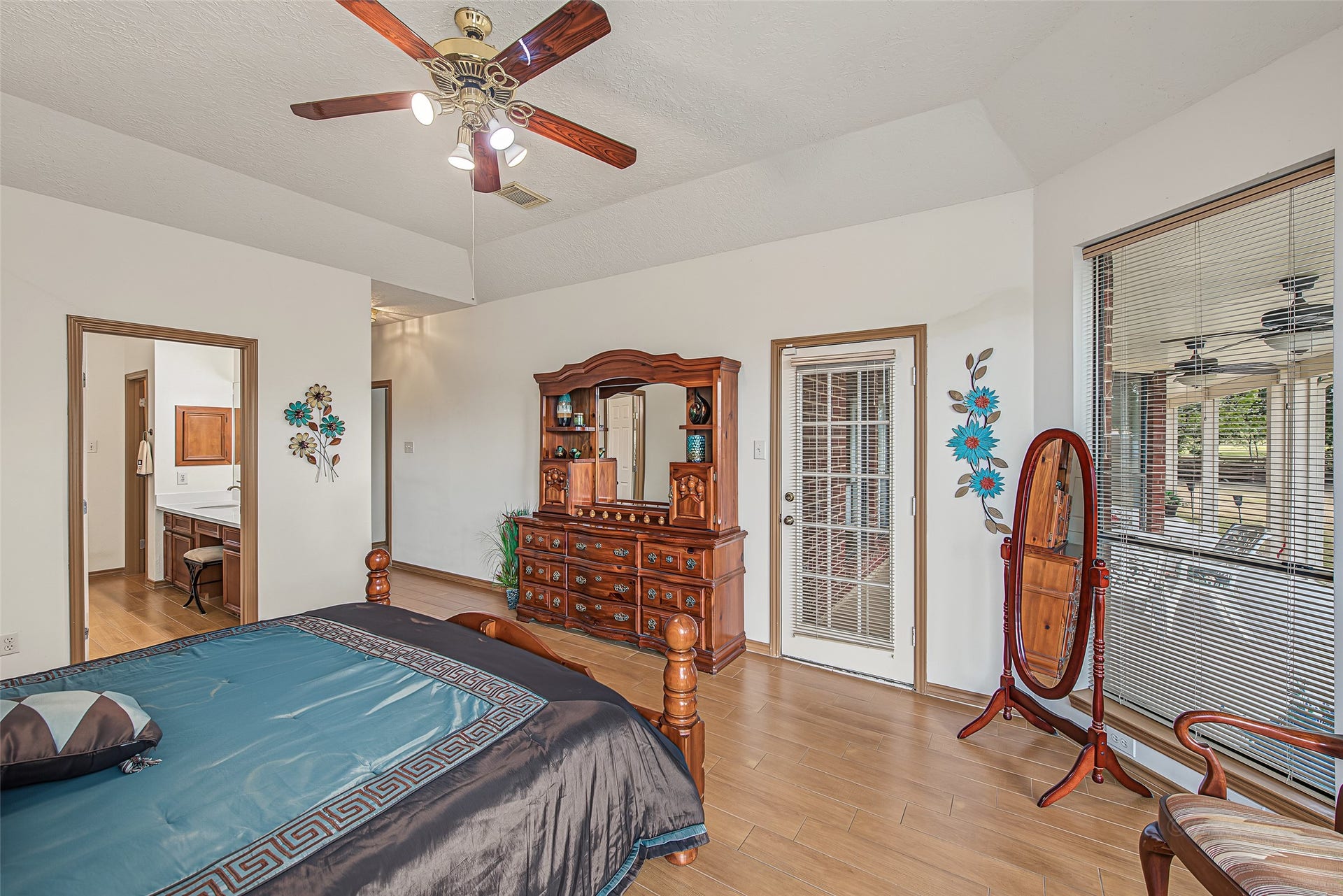 1345 Peach Ridge Road, Brookshire, TX 77423 The ensuite doorway opens to a generous primary bath and vanity area.