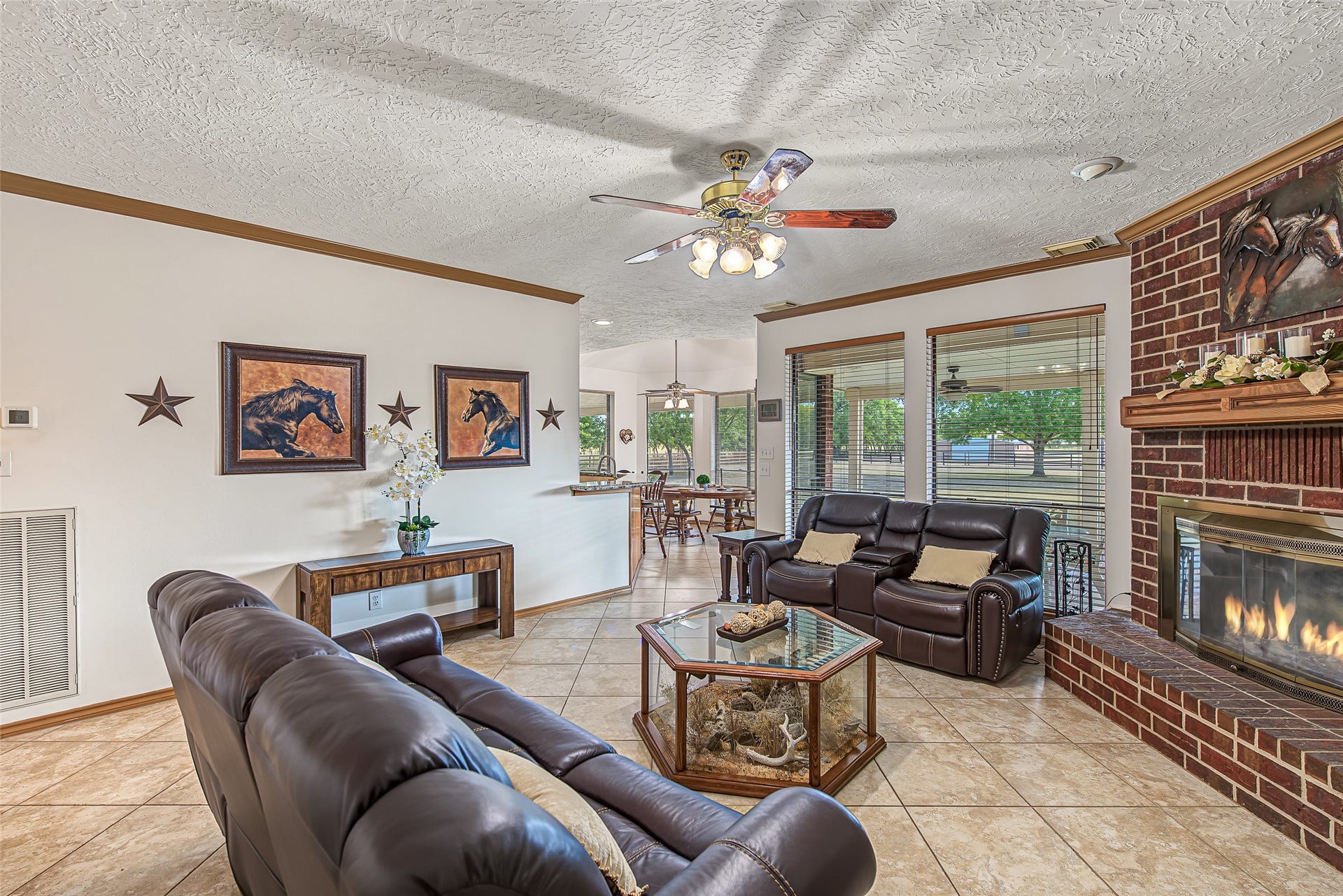 1345 Peach Ridge Road, Brookshire, TX 77423 Large windows flood the space with natural light, while a central ceiling fan provides added comfort.
