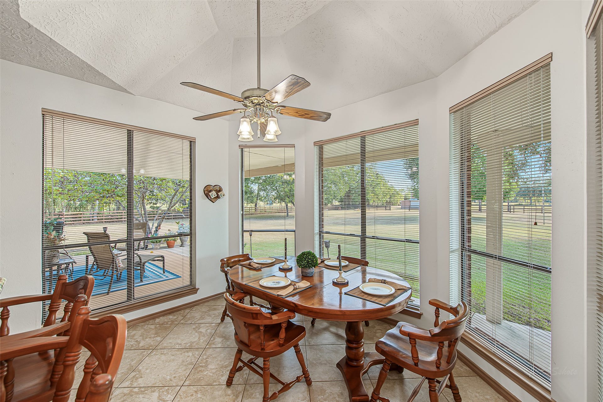 1345 Peach Ridge Road, Brookshire, TX 77423 Framed by a bay of tall, picture-style windows, the dining area captures peaceful views of the surrounding outdoor landscape while flooding the space with natural light.