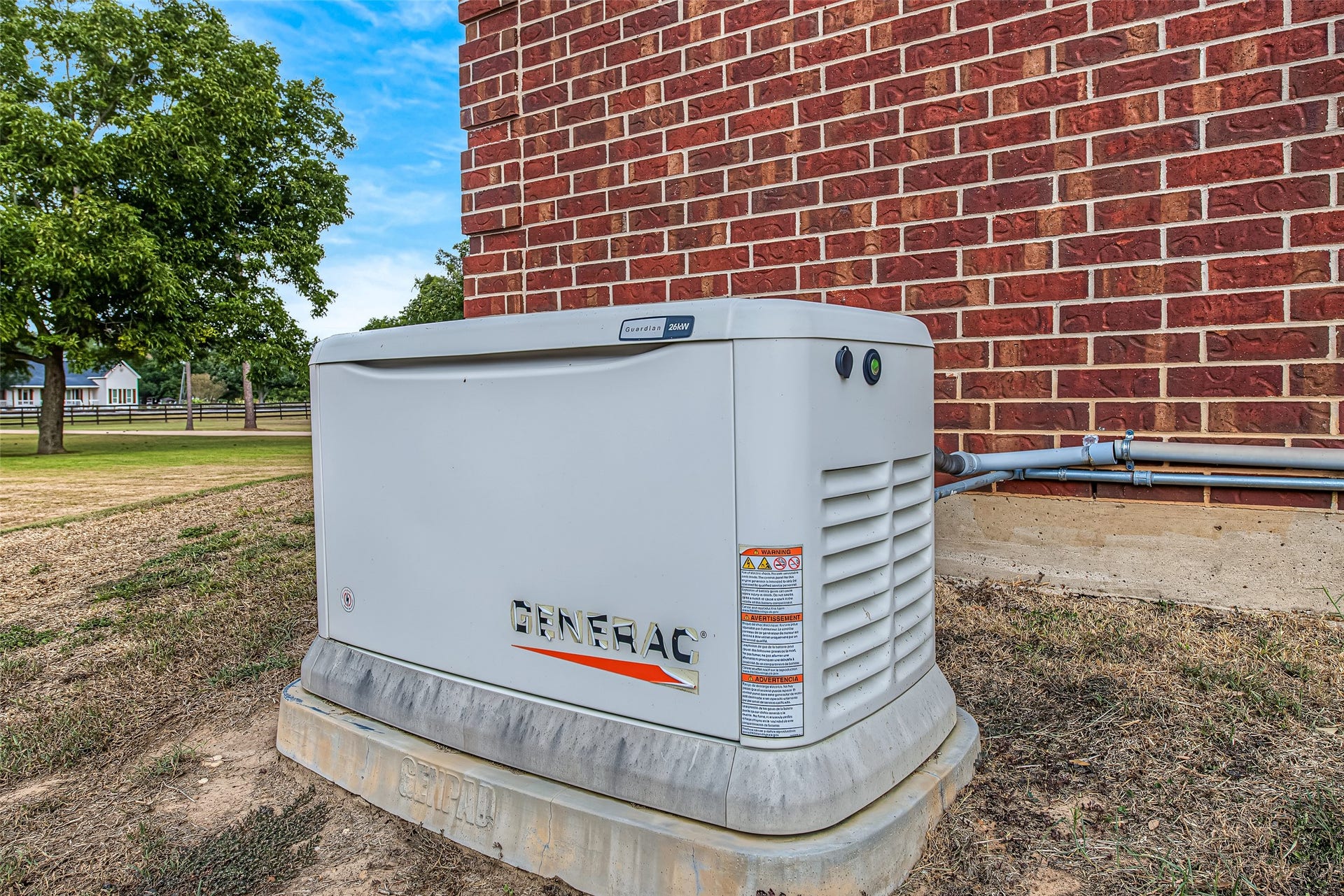 1345 Peach Ridge Road, Brookshire, TX 77423 Adding an essential layer of reliability and peace of mind to rural living, the home comes equipped with a whole-house Generac standby generator mounted on a secure concrete pad along the exterior brick wall. Engineered to automatically supply seamless backup power during utility outages, this critical system keeps essential appliances, climate control, and home features running without interruption.