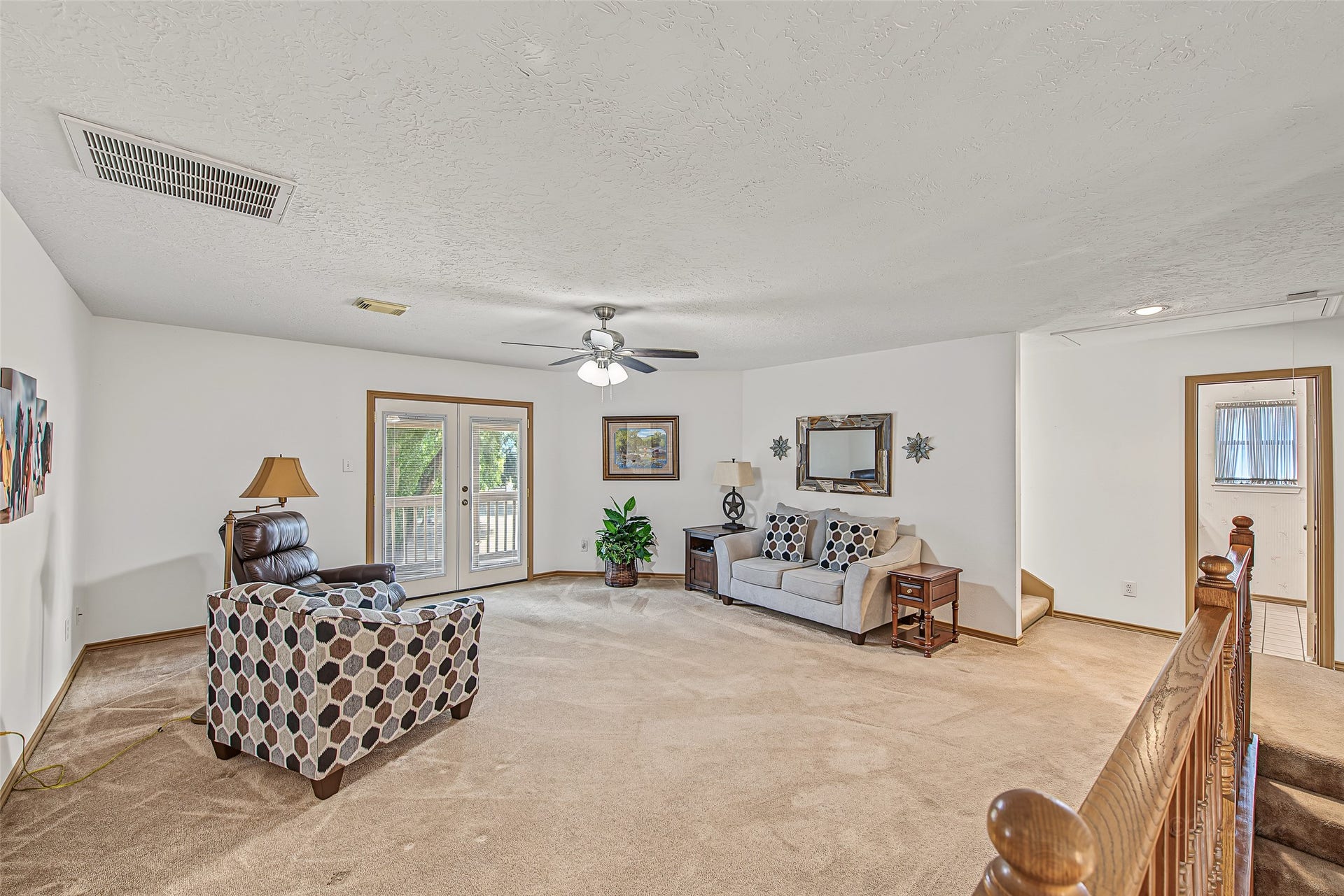 1345 Peach Ridge Road, Brookshire, TX 77423 Set off by double glass French doors that open directly onto a private second-story balcony, this flexible space offers direct access to adjacent bedroomsmaking it an exceptional retreat for family movie nights, a media room, or a dedicated kids' play area.