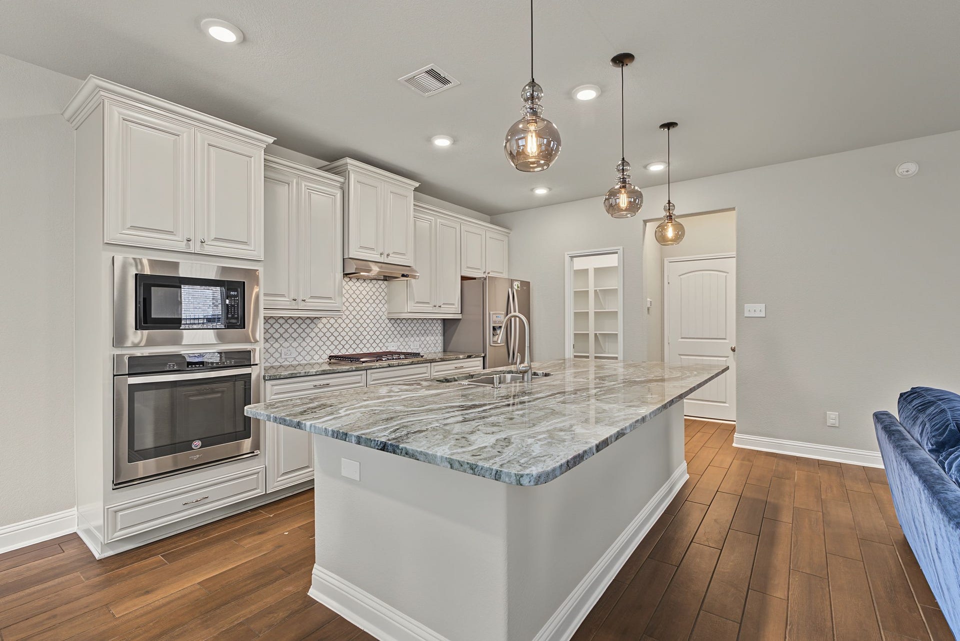 16 Centennial Ridge Place, The Woodlands, TX 77354 A view of the kitchen, walk in pantry and drop zone just off the garage entry.