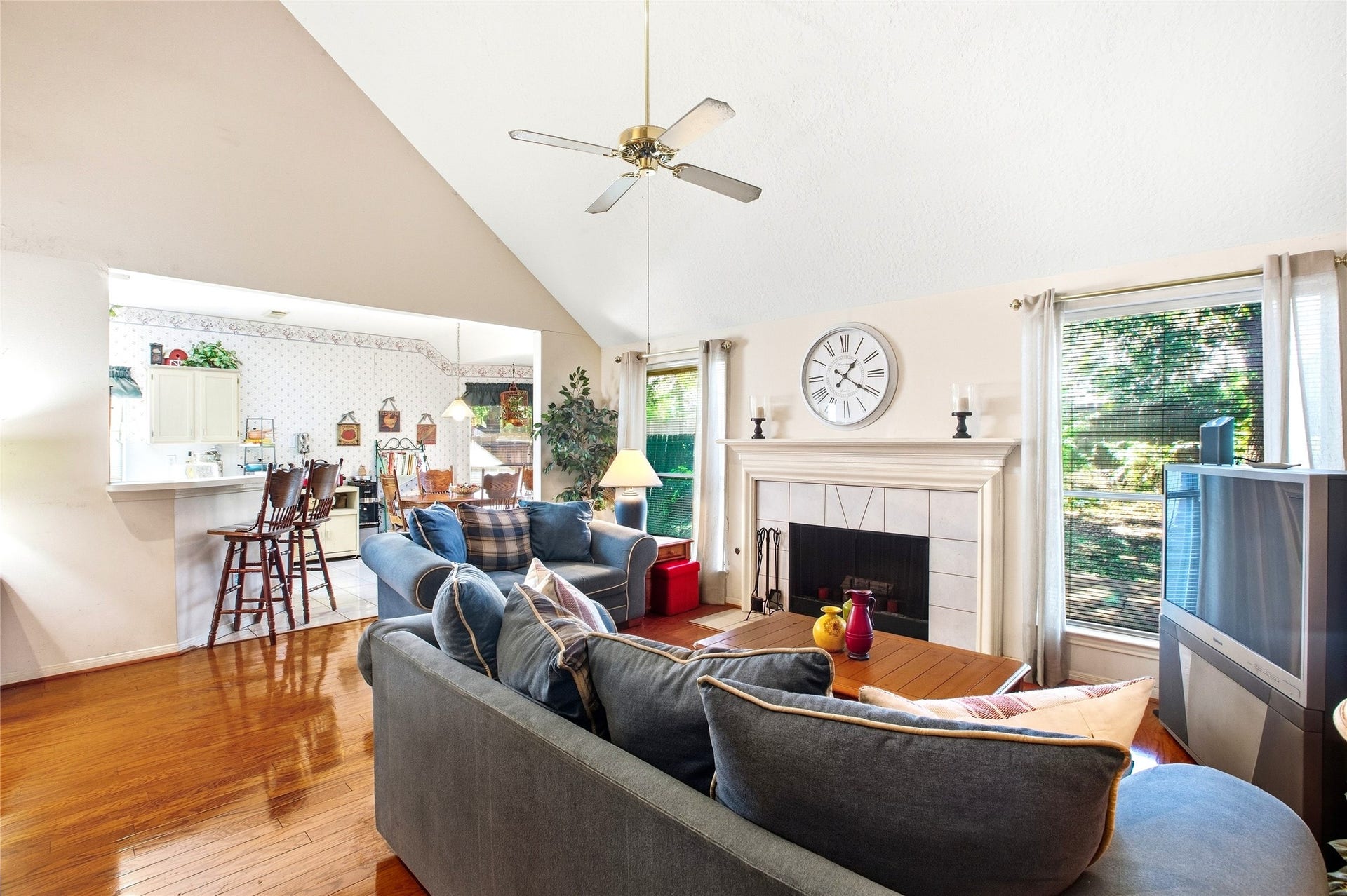 Family room open to the kitchen through a breakfast-bar pass-through, ideal for entertaining.