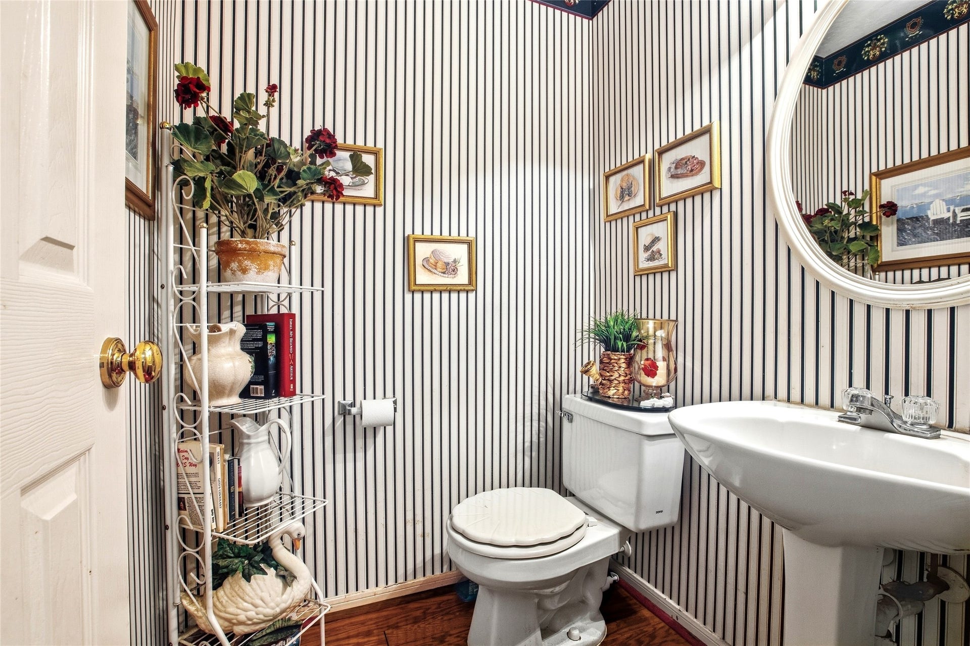 Half bath for guests with a pedestal sink.