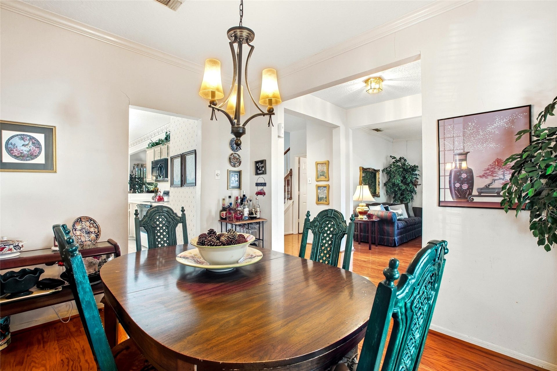 Dining room with a chandelier and easy flow to the kitchen and front entry.