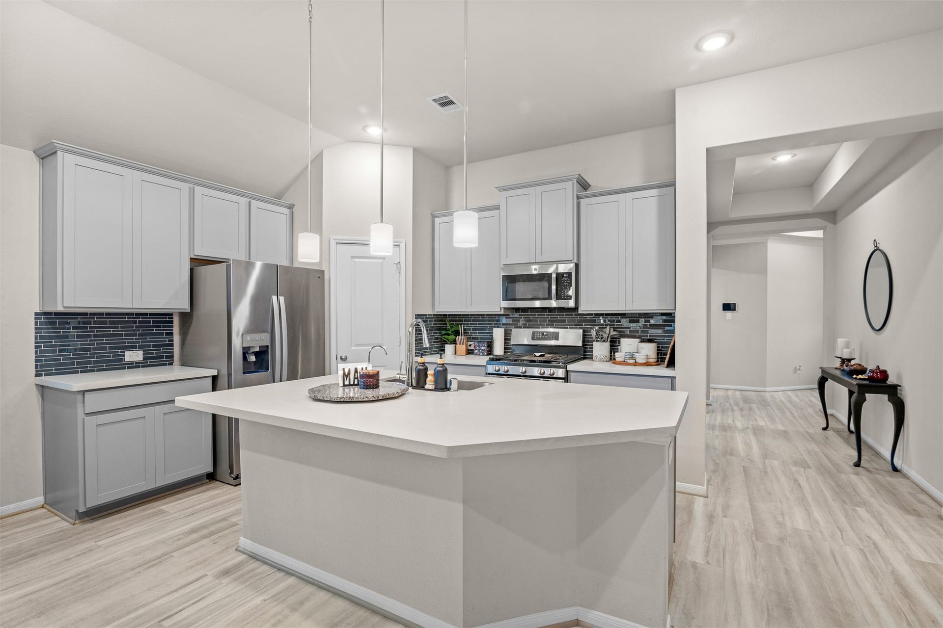 3707 Amoroso Drive, Iowa Colony, TX 77583 The Kitchen's gathering spot centers around a spacious island framed by pendant lights and great cabinet space.
