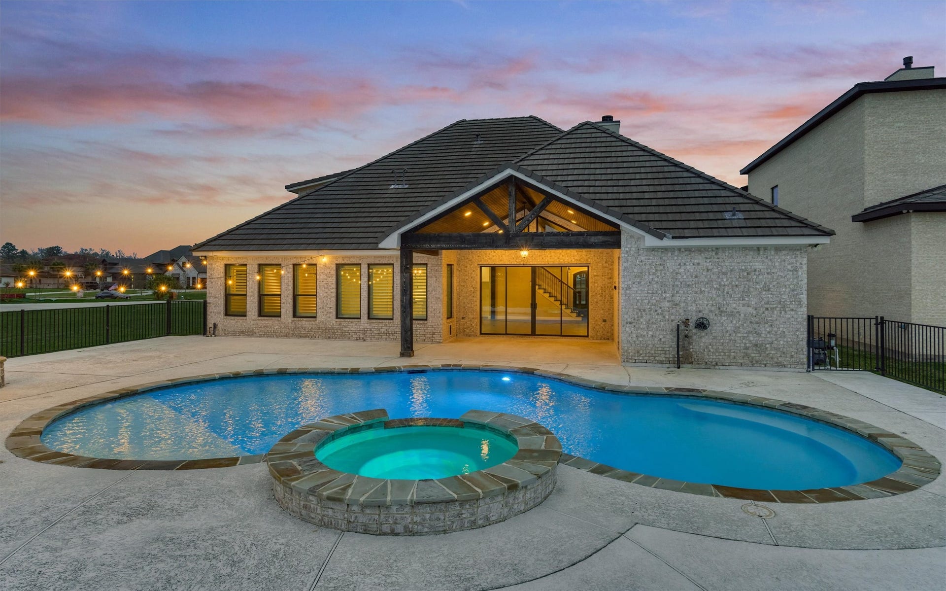 11618 Renaissance Drive, Montgomery, TX 77356 Backyard space with lighted pool and hot tub.