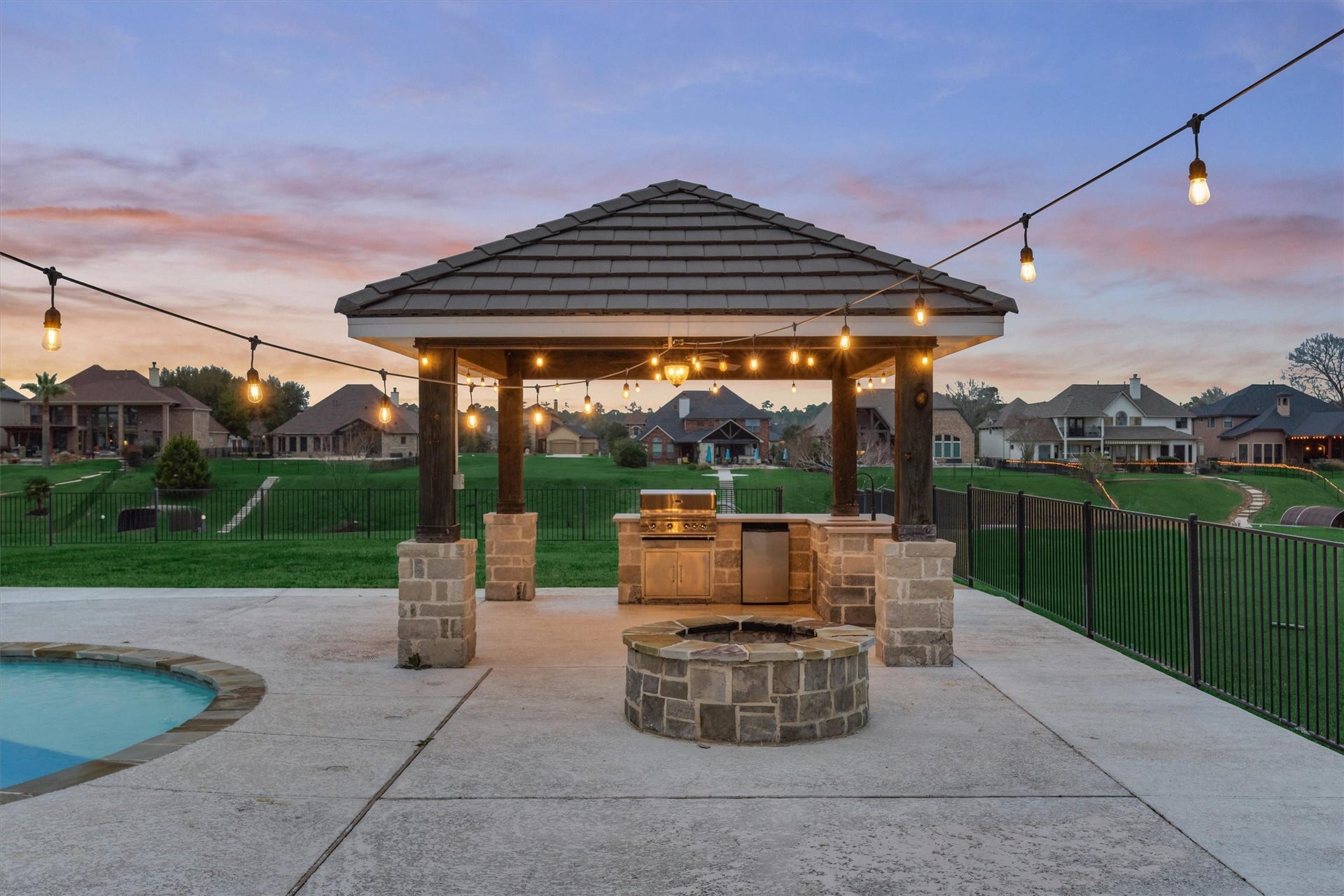 11618 Renaissance Drive, Montgomery, TX 77356 Gas firepit near the pool and outdoor kitchen.