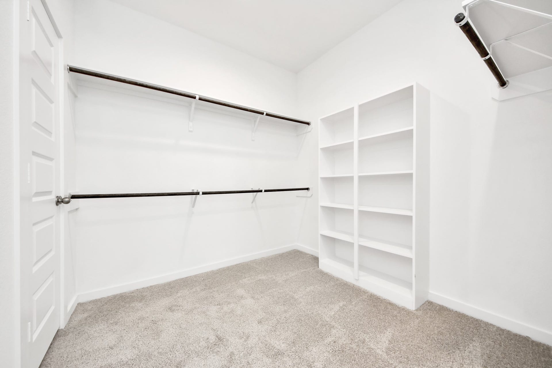 16006 Sycamore Maple Lane, Cypress, TX 77429 Walk-in closet that epitomizes luxury and practicality. This generously sized space features built-in shelving, offering abundant room for impeccable organization. High ceilings and recessed lighting create a bright and welcoming ambiance. Sample photo of completed home with similar floor plan. Actual colors and selections may vary.
