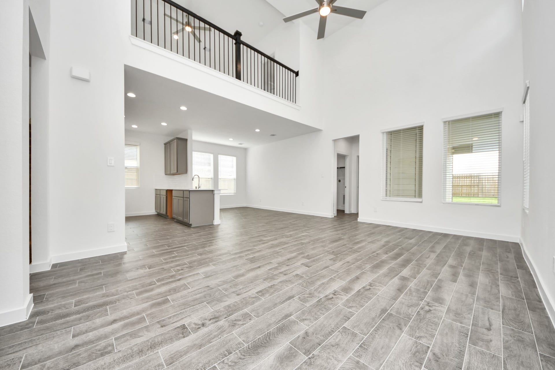 16006 Sycamore Maple Lane, Cypress, TX 77429 Welcome family and guests to your charming living room! With its high ceilings, recessed lighting, ceiling fan, custom paint, beautiful flooring, and large windows that let in abundant natural light, this room is perfect for gatherings. Sample photo of completed home with similar floor plan. Actual colors and selections may vary.