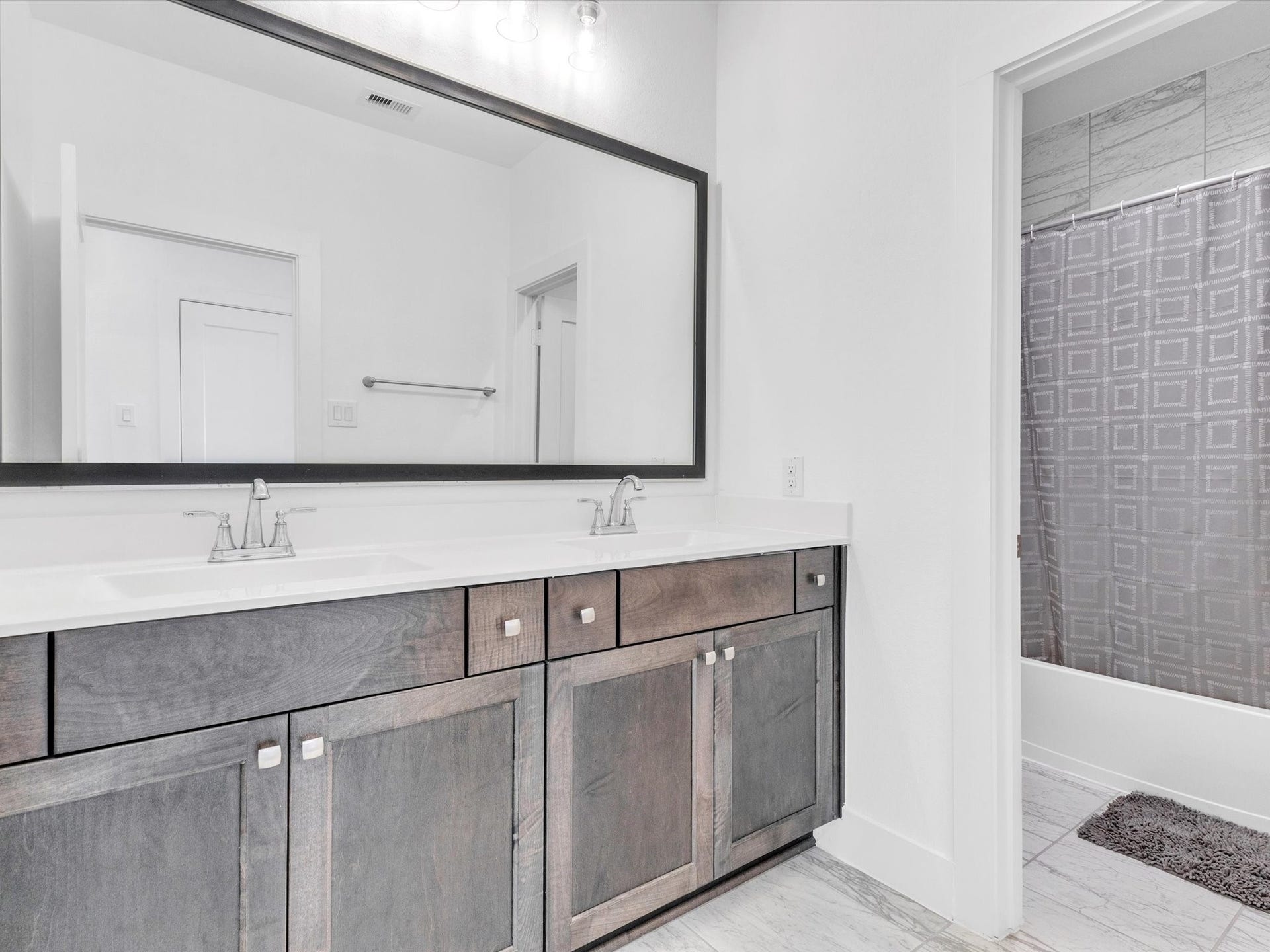 10718 Hidden Rock Drive, Missouri City, TX 77459 The upstairs bath offers a long dual-sink vanity with generous counter and storage space, making busy mornings easier for family or guests.
