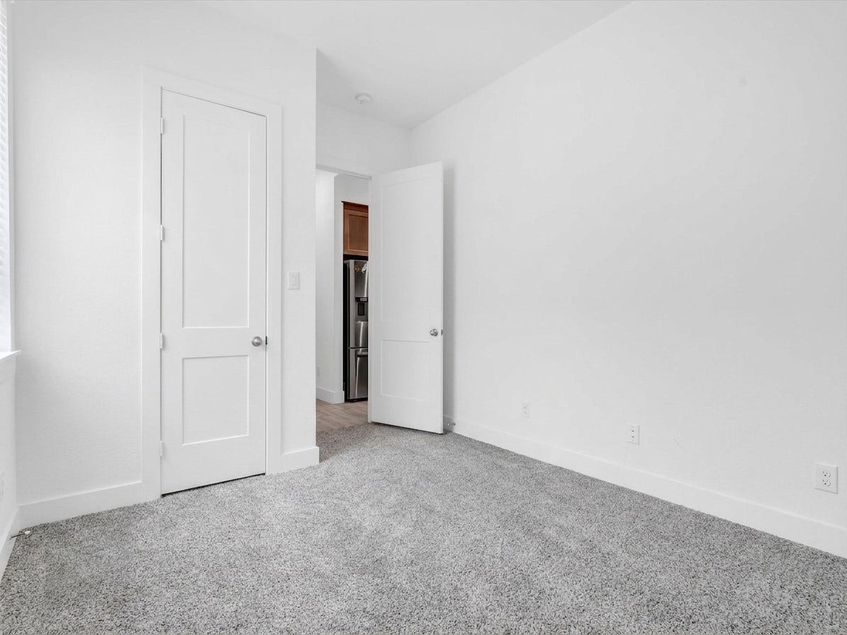 10718 Hidden Rock Drive, Missouri City, TX 77459 This spacious first-floor secondary bedroom includes a dedicated closet and convenient access to a full bath, creating a comfortable and private guest suite.