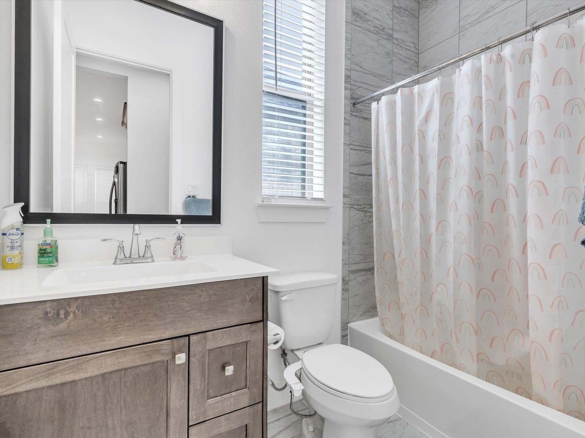 10718 Hidden Rock Drive, Missouri City, TX 77459 A full first-floor bath conveniently serves the secondary bedroom and guests, enhancing the homes versatile two-bedroom-down layout.