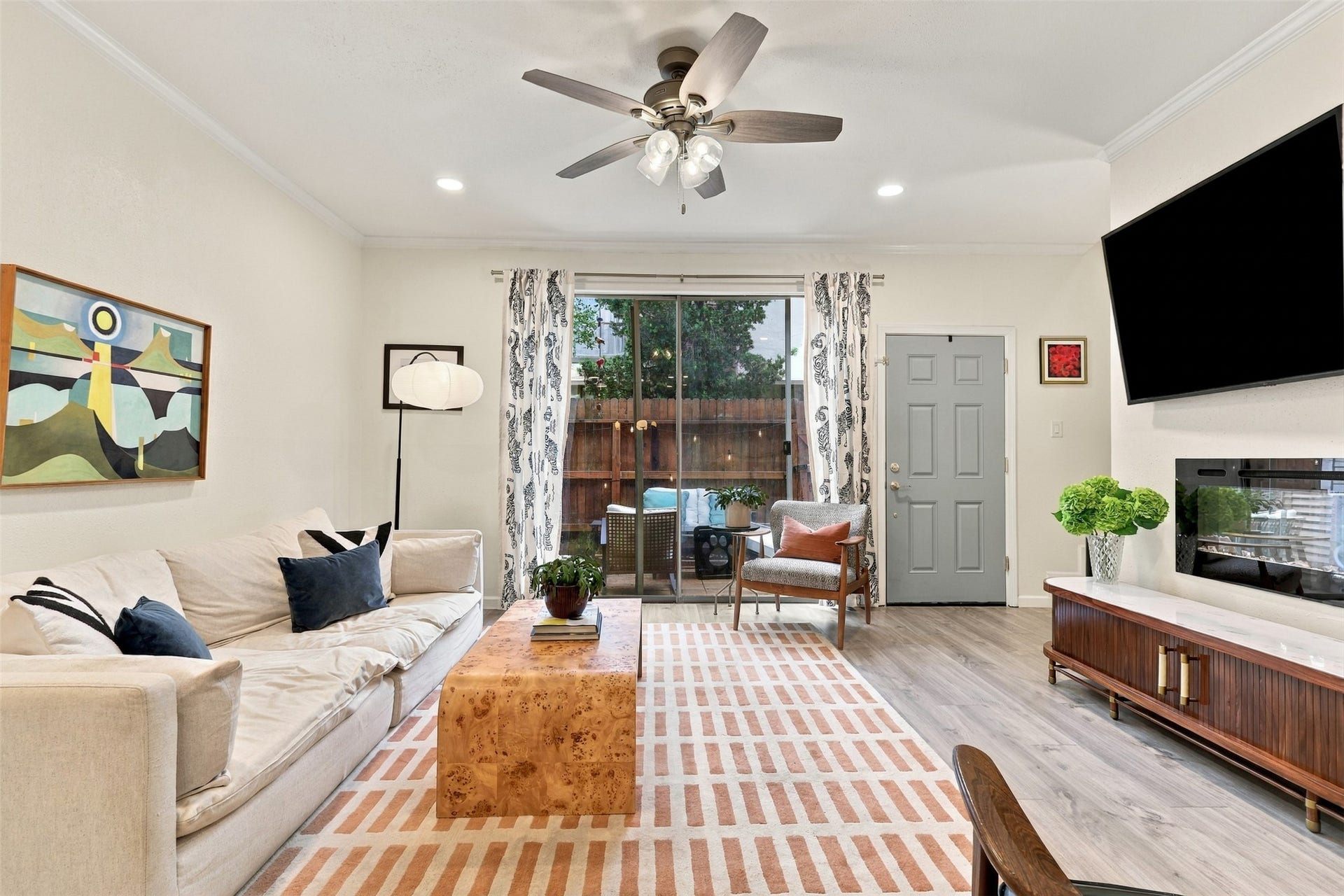 1201 Mcduffie Street, #212, Houston, TX 77019 This view shows how naturally the living room extends to the private patio for indoor-outdoor living.
