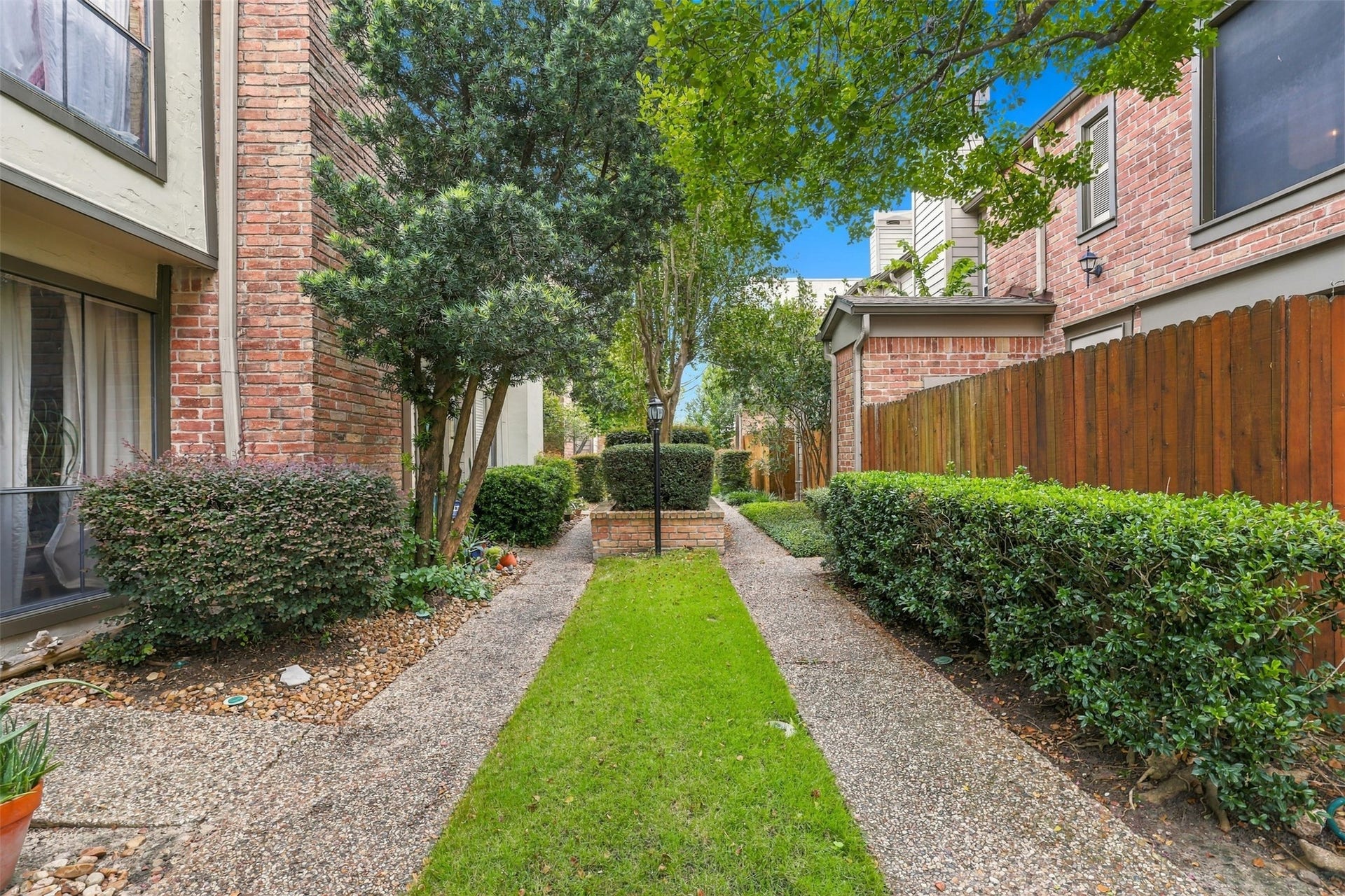 1201 Mcduffie Street, #212, Houston, TX 77019 Landscaped paths and mature greenery create a welcoming approach to the residence.