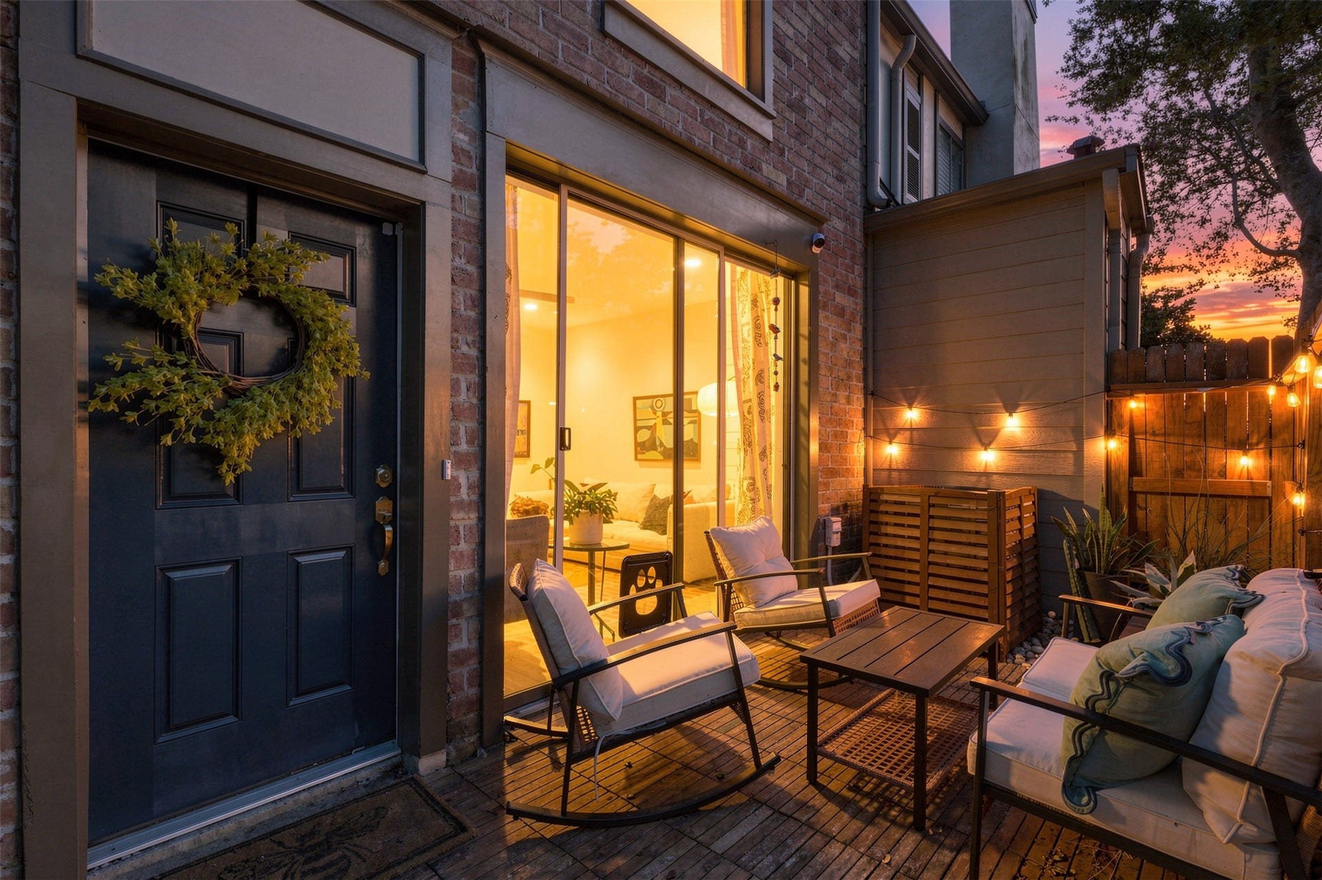 1201 Mcduffie Street, #212, Houston, TX 77019 Charming outdoor patio with cozy seating, warm string lights, and a welcoming atmosphere perfect for evening relaxation.