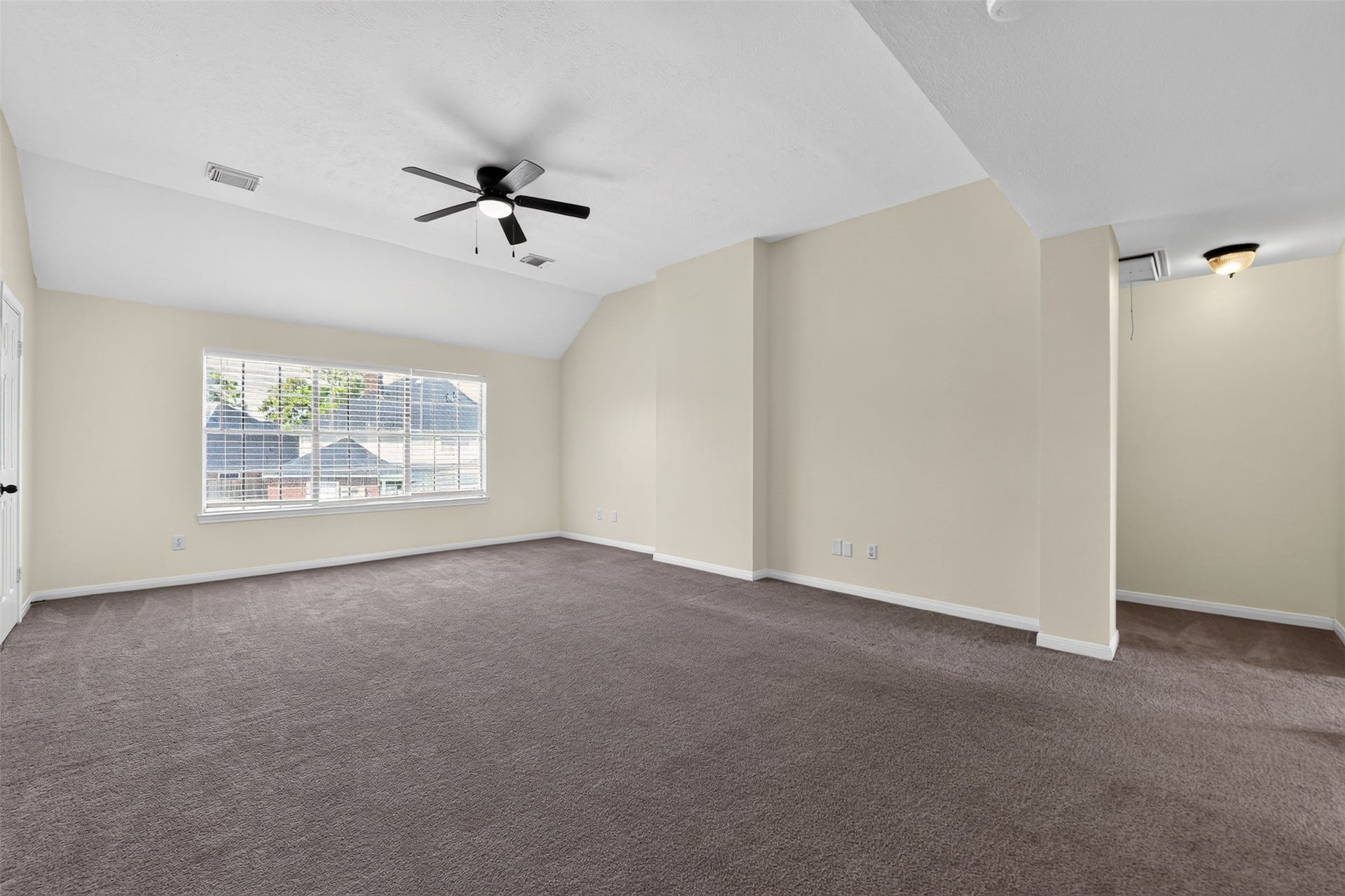 Upstairs family room leading to secondary bathroom.