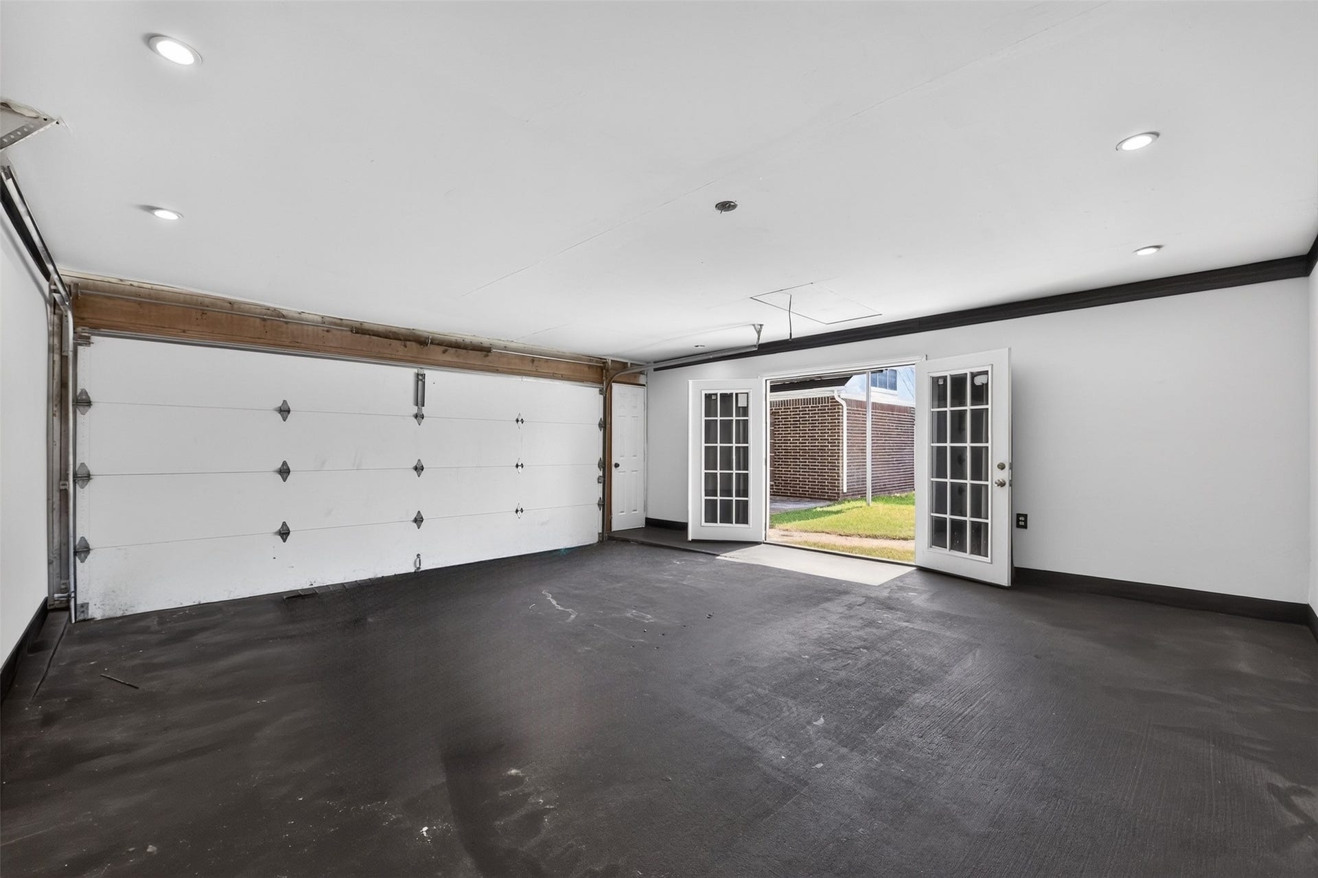 Garage with doorway leading to pool.