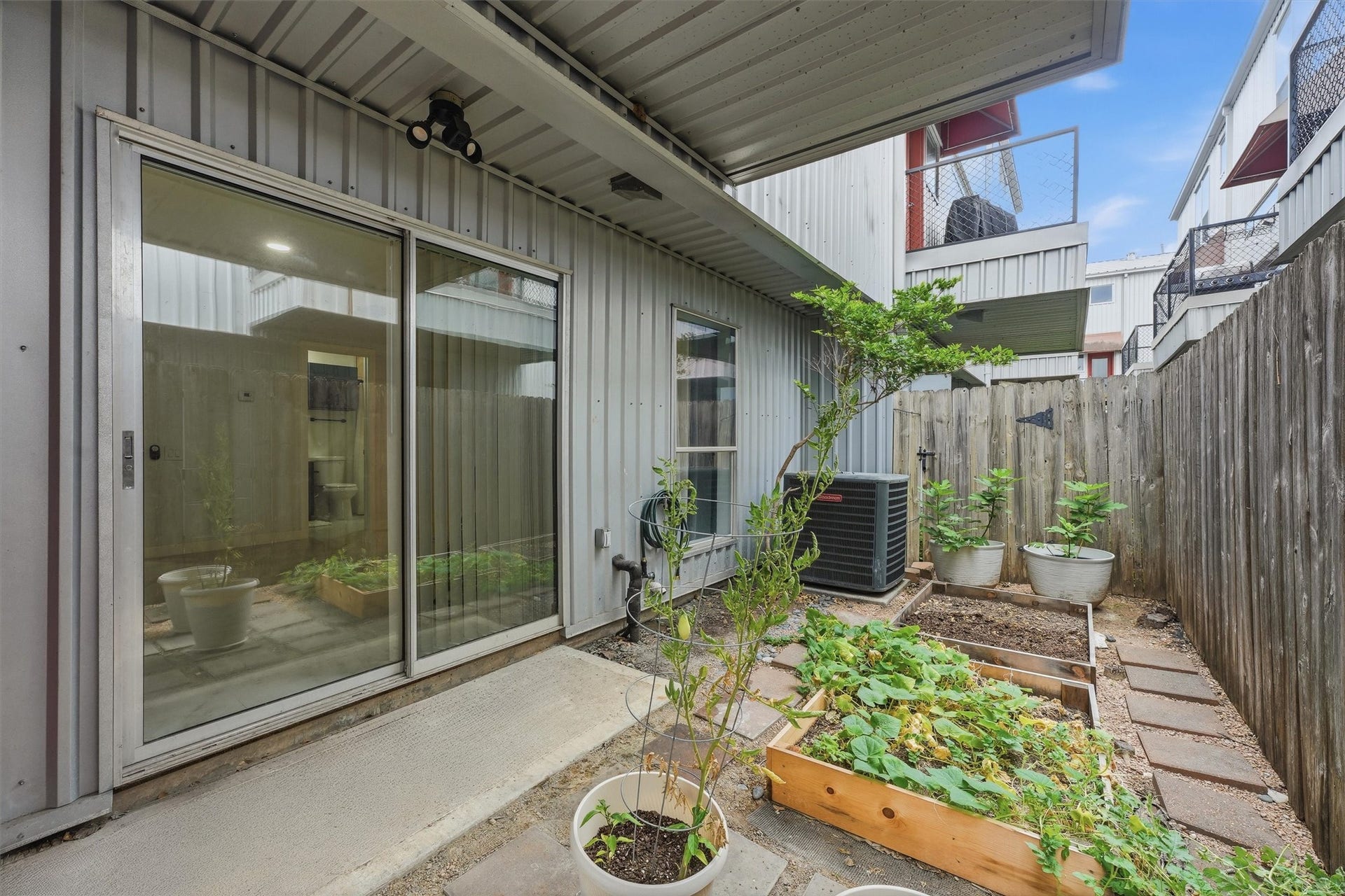 Private first floor patio. Imagine creating your own urban garden here! There's also a small storage room on this level.