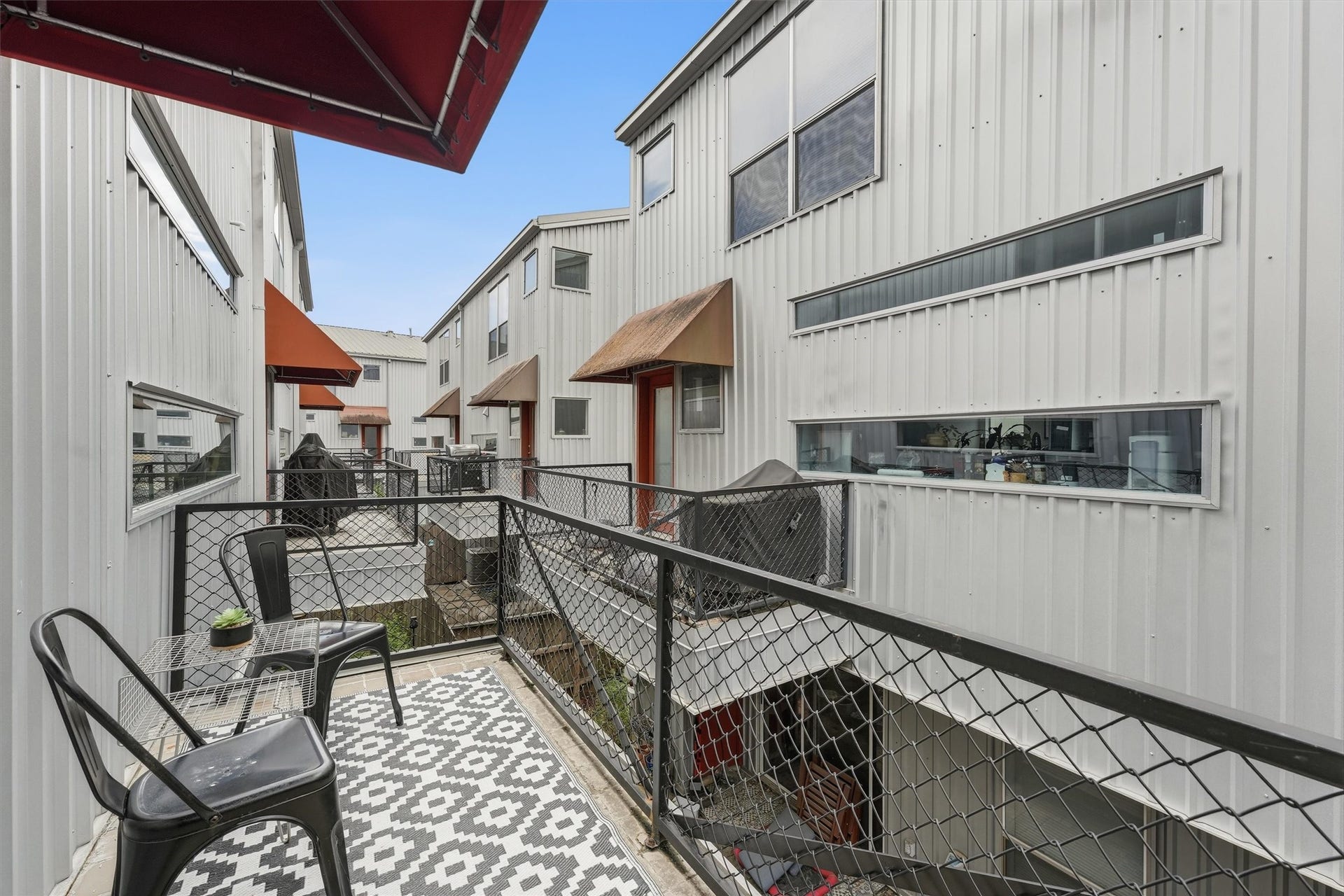 Second-floor balcony right off the kitchen is a great place to grill, sip coffee, or entertain friends.