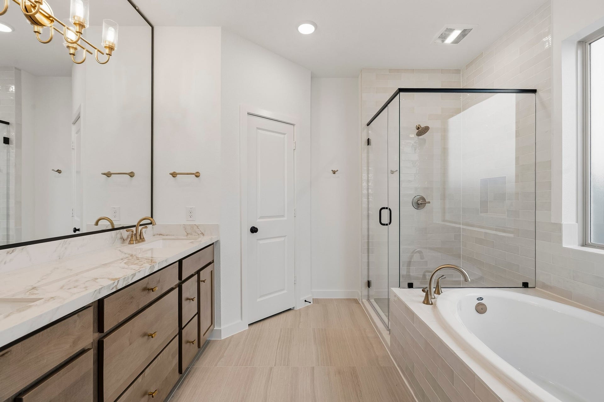 4510 Sunny Hazel Lane, Fulshear, TX 77441 Primary bath with dual vanities, soaking tub, separate shower, and natural light.