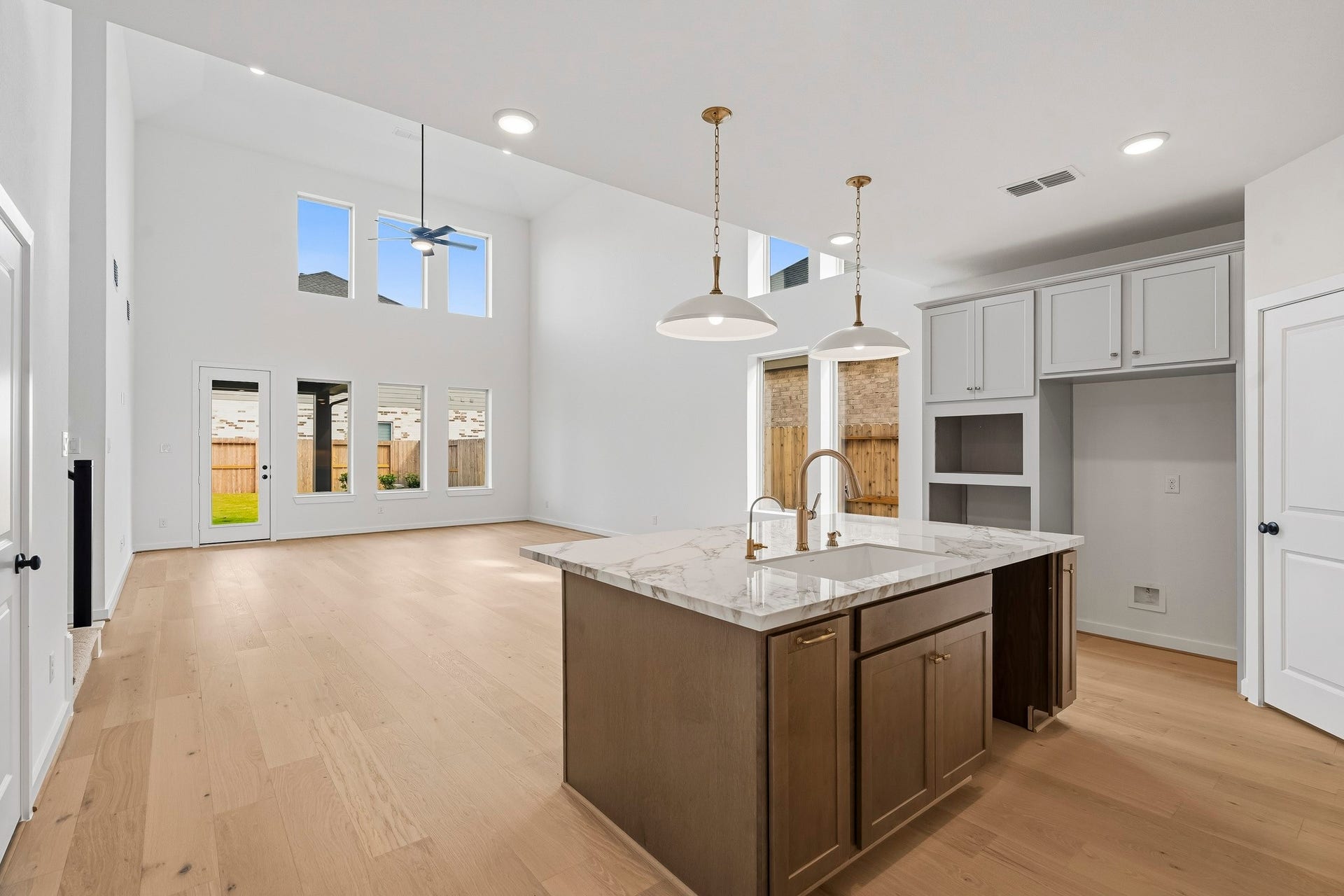 4510 Sunny Hazel Lane, Fulshear, TX 77441 Open-concept kitchen and living area with soaring ceilings and abundant natural light.
