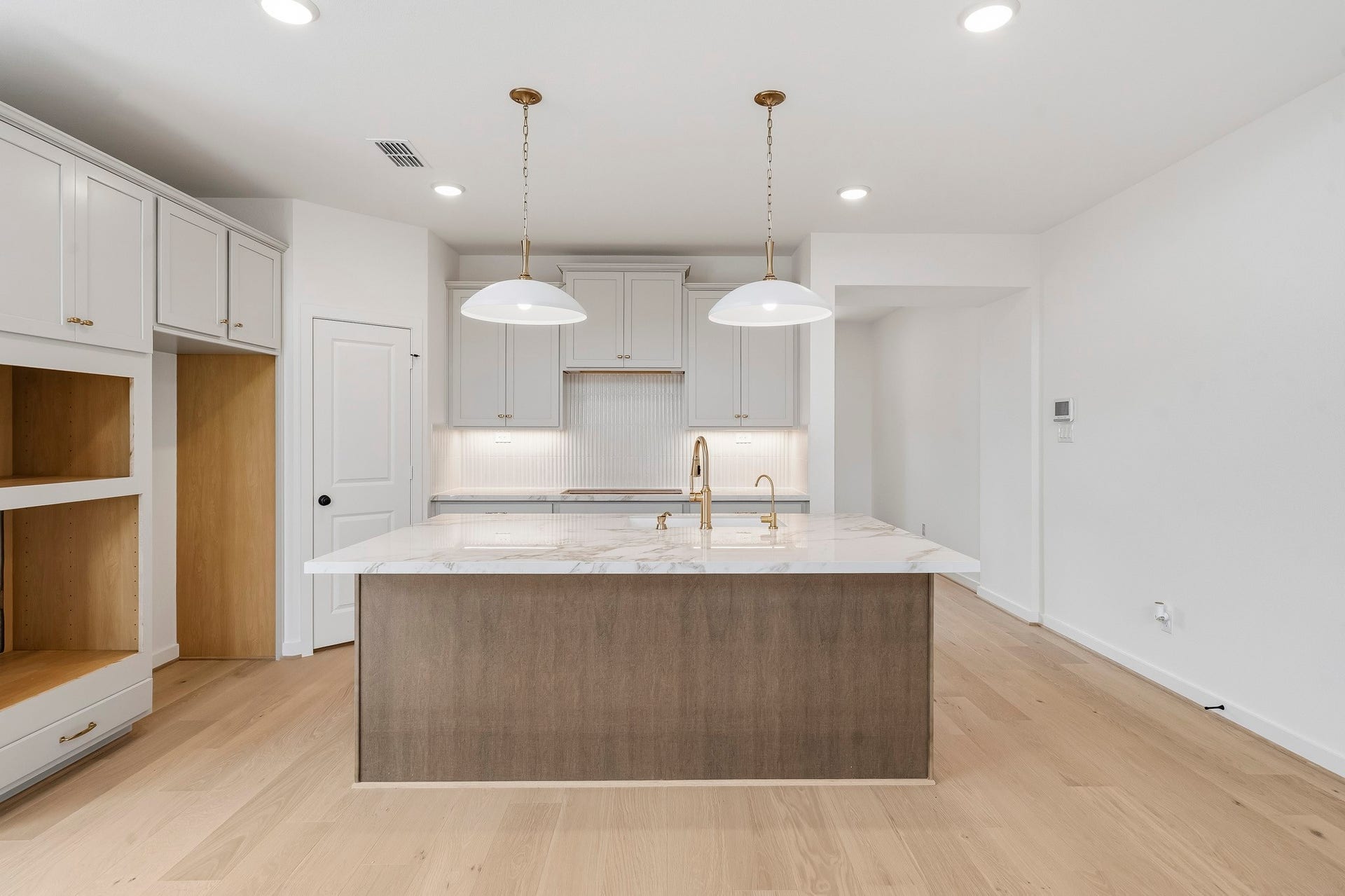 4510 Sunny Hazel Lane, Fulshear, TX 77441 Spacious kitchen with oversized island, quartz countertops, pendant lighting, and ample cabinetry.