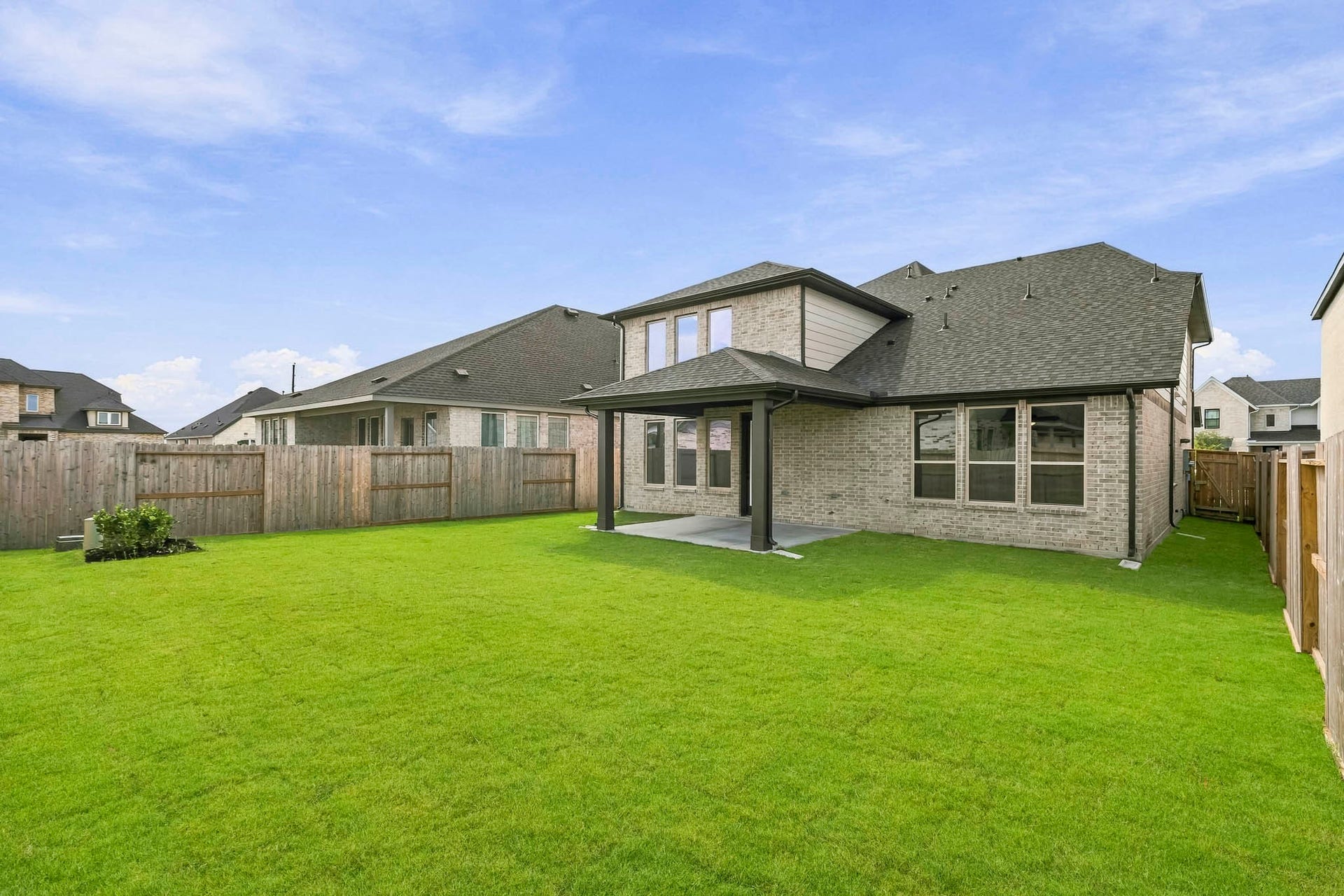4510 Sunny Hazel Lane, Fulshear, TX 77441 Spacious fenced backyard with covered patio and plenty of room for outdoor living.