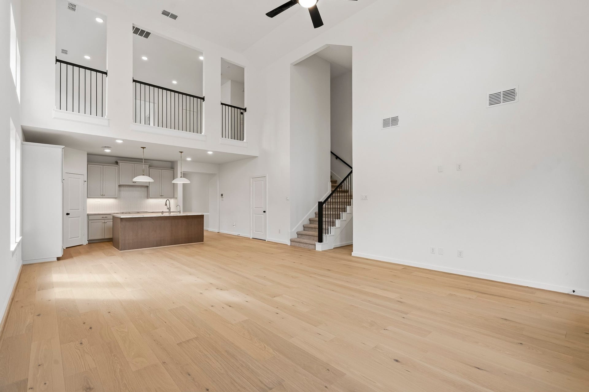 4510 Sunny Hazel Lane, Fulshear, TX 77441 Spacious two-story living area open to the kitchen with upstairs overlook.