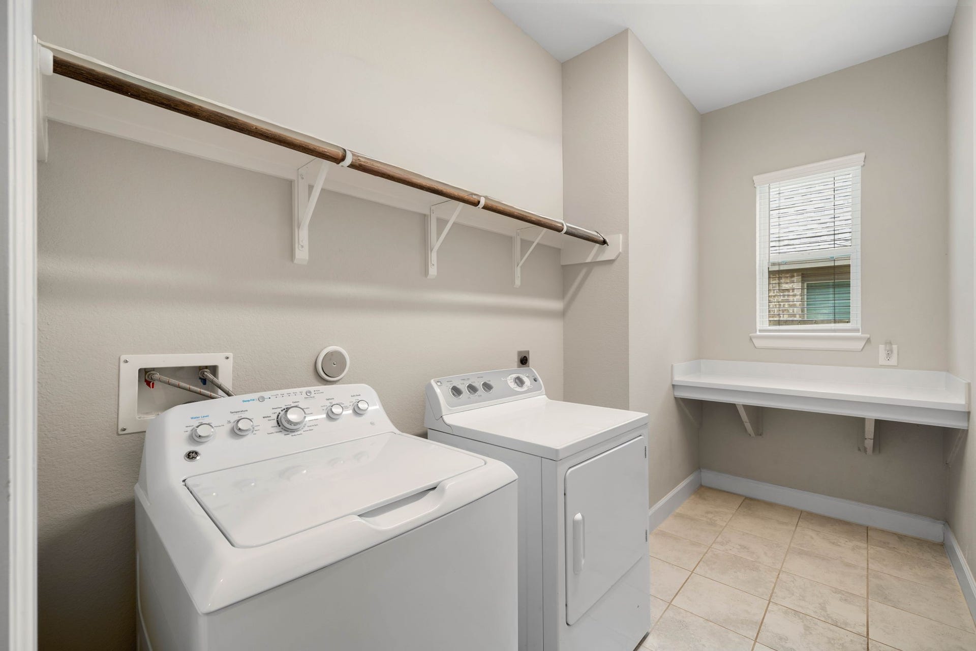 6922 Goldstrum Way, Katy, TX 77493 The spacious utility room offers washer and dryer connections, built-in hanging rod storage, and a folding counter plenty of room to make laundry day easy.