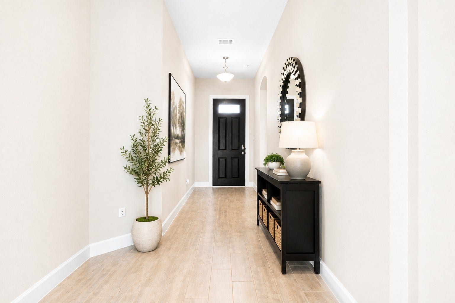 6922 Goldstrum Way, Katy, TX 77493 A wide hallway with beautiful flooring welcomes you inside, leading toward the open living area with views of natural light pouring in from the windows ahead.