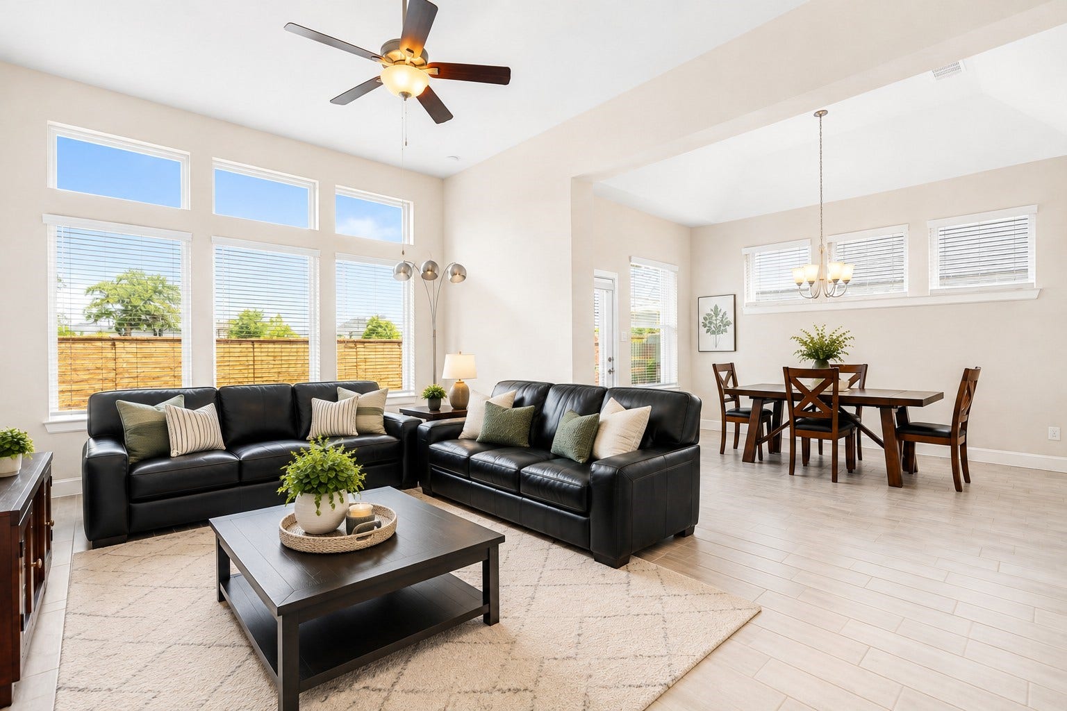6922 Goldstrum Way, Katy, TX 77493 Floor-to-ceiling windows fill the living room with natural light, while the space flows seamlessly into the adjoining dining area, ideal for everyday living and entertaining.