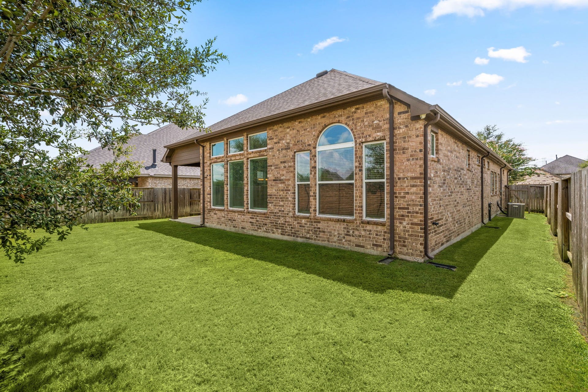 6922 Goldstrum Way, Katy, TX 77493 Mature trees and a fully fenced yard create a private outdoor retreat, ideal for relaxing or entertaining.