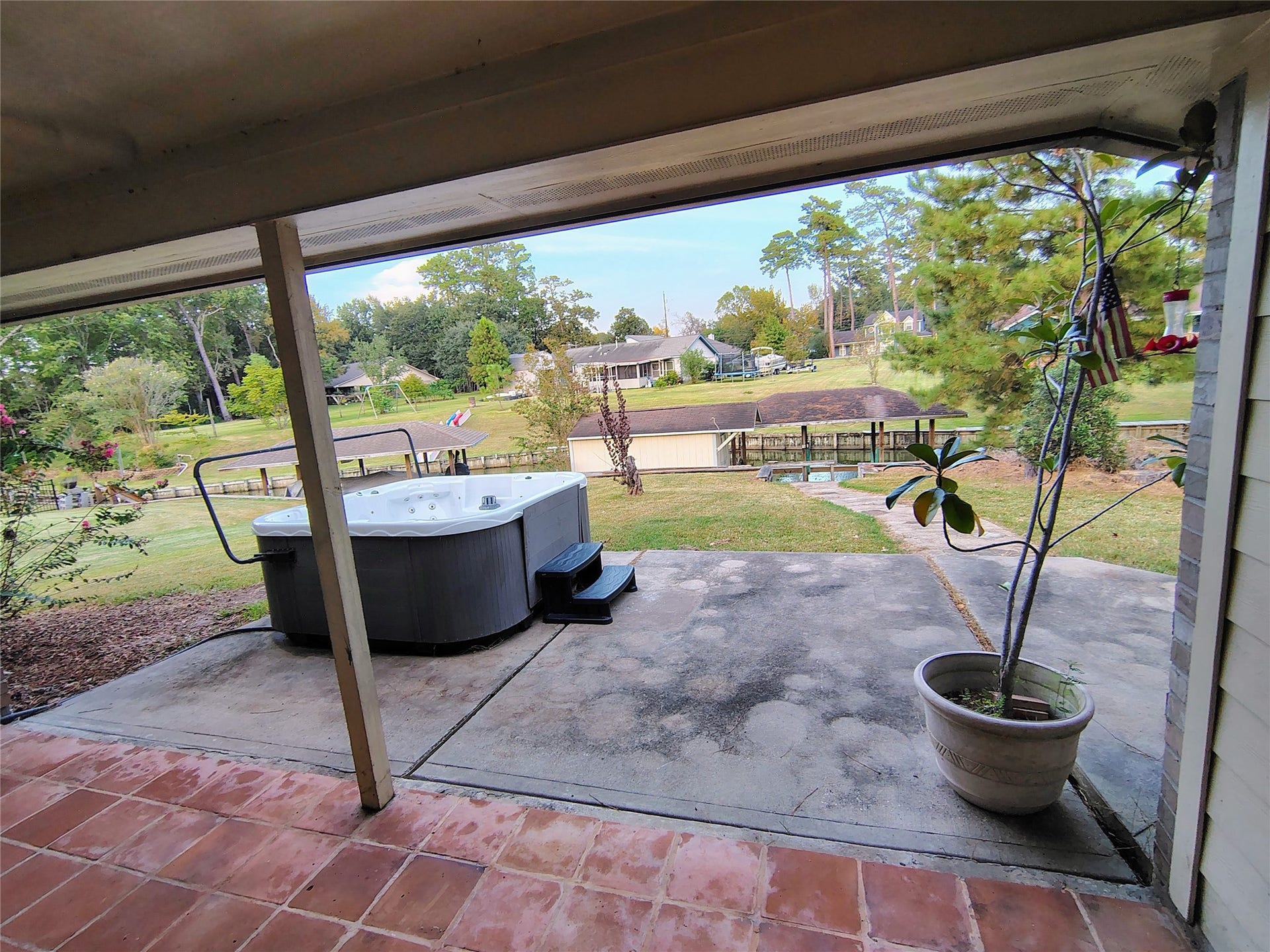 3443 Shore Shadows Drive, Crosby, TX 77532 Covered back patio overlooking the spectacular view of the lake while relaxing in the hot tub.