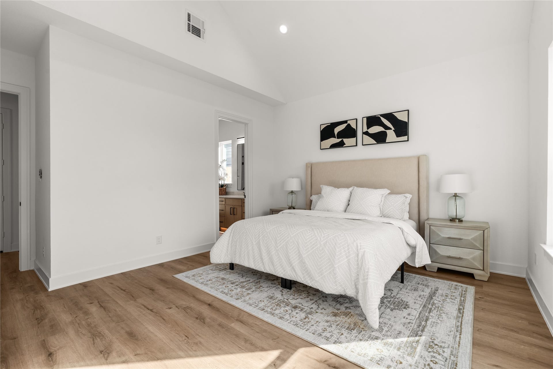 6714 Tierwester Street, Houston, TX 77021 The primary suite's vaulted ceiling creates a dramatic sense of height, with its angular geometry lending architectural interest to an otherwise minimalist interior.