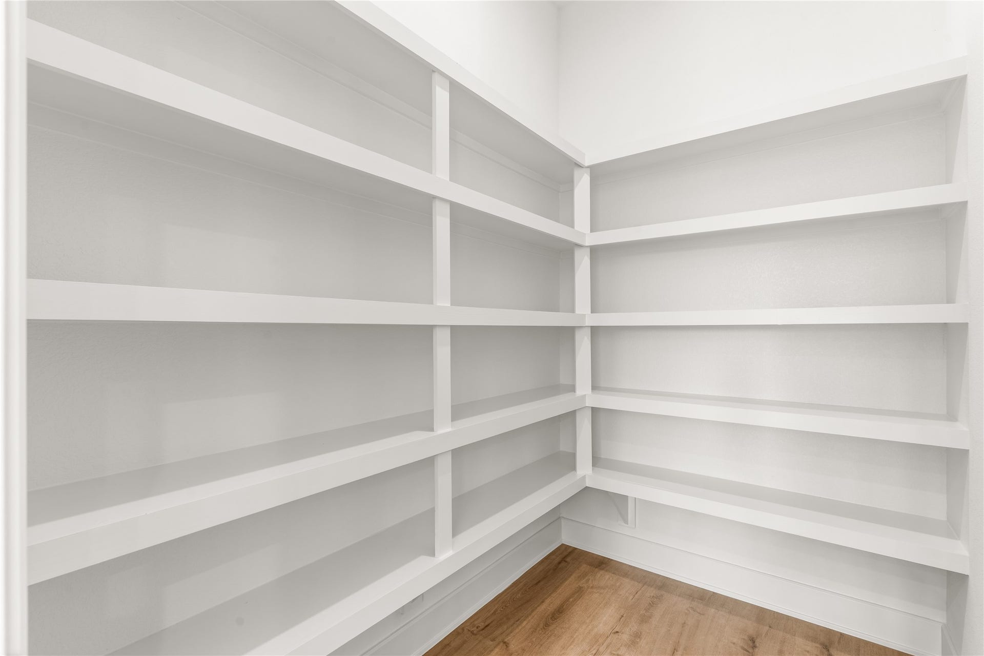 6714 Tierwester Street, Houston, TX 77021 A generously appointed walk-in pantry offers extensive built-in shelving across multiple walls, providing dedicated storage for dry goods, kitchen essentials, and small appliances.