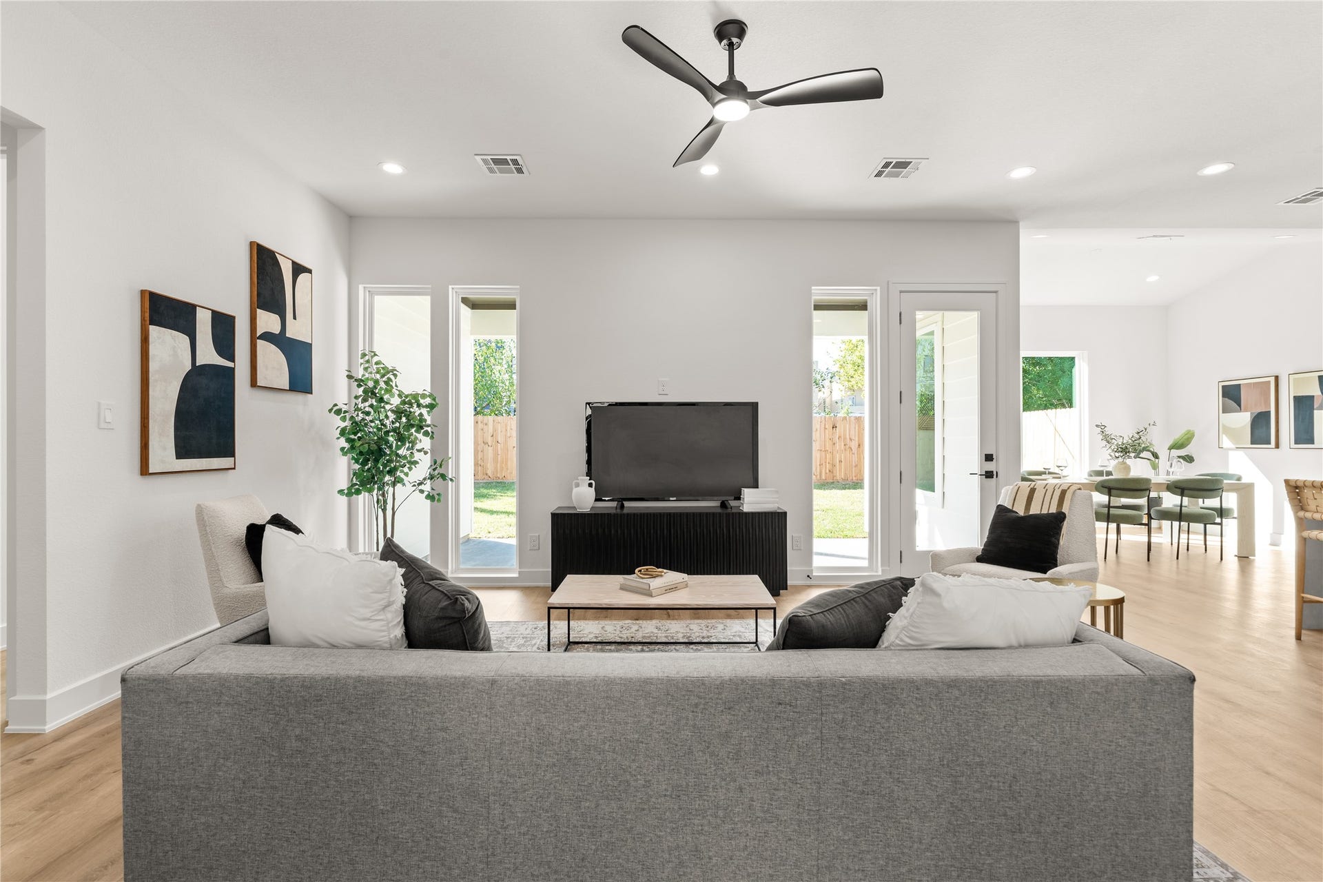 6714 Tierwester Street, Houston, TX 77021 Carefully positioned windows introduce a sense of rhythm and symmetry to the open concept living area, while an uninterrupted transition to the dining area enhances the home's cohesive design.