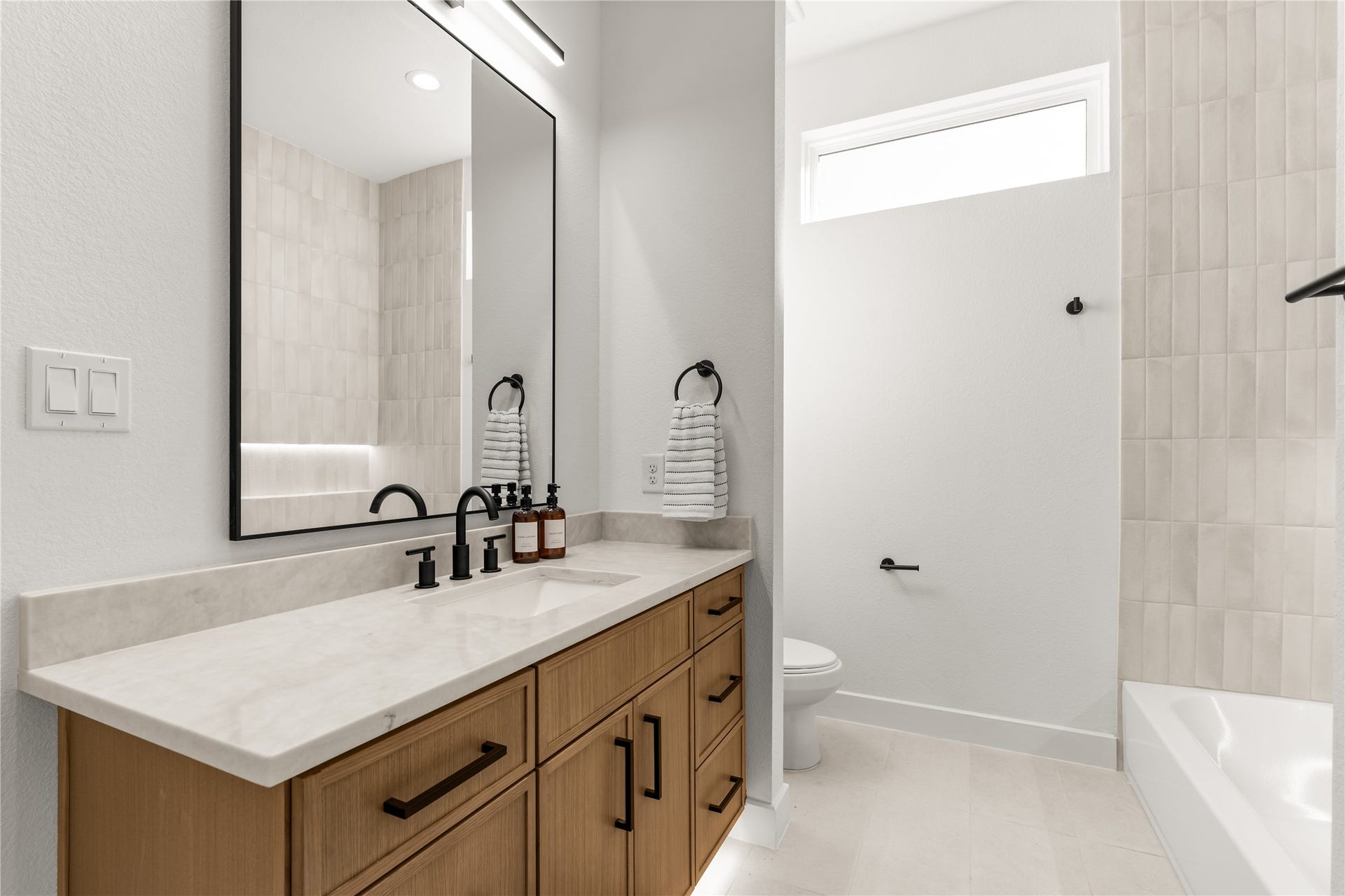 6714 Tierwester Street, Houston, TX 77021 A cohesive selection of finishes defines this secondary bathroom, where understated materials create a polished yet welcoming atmosphere.