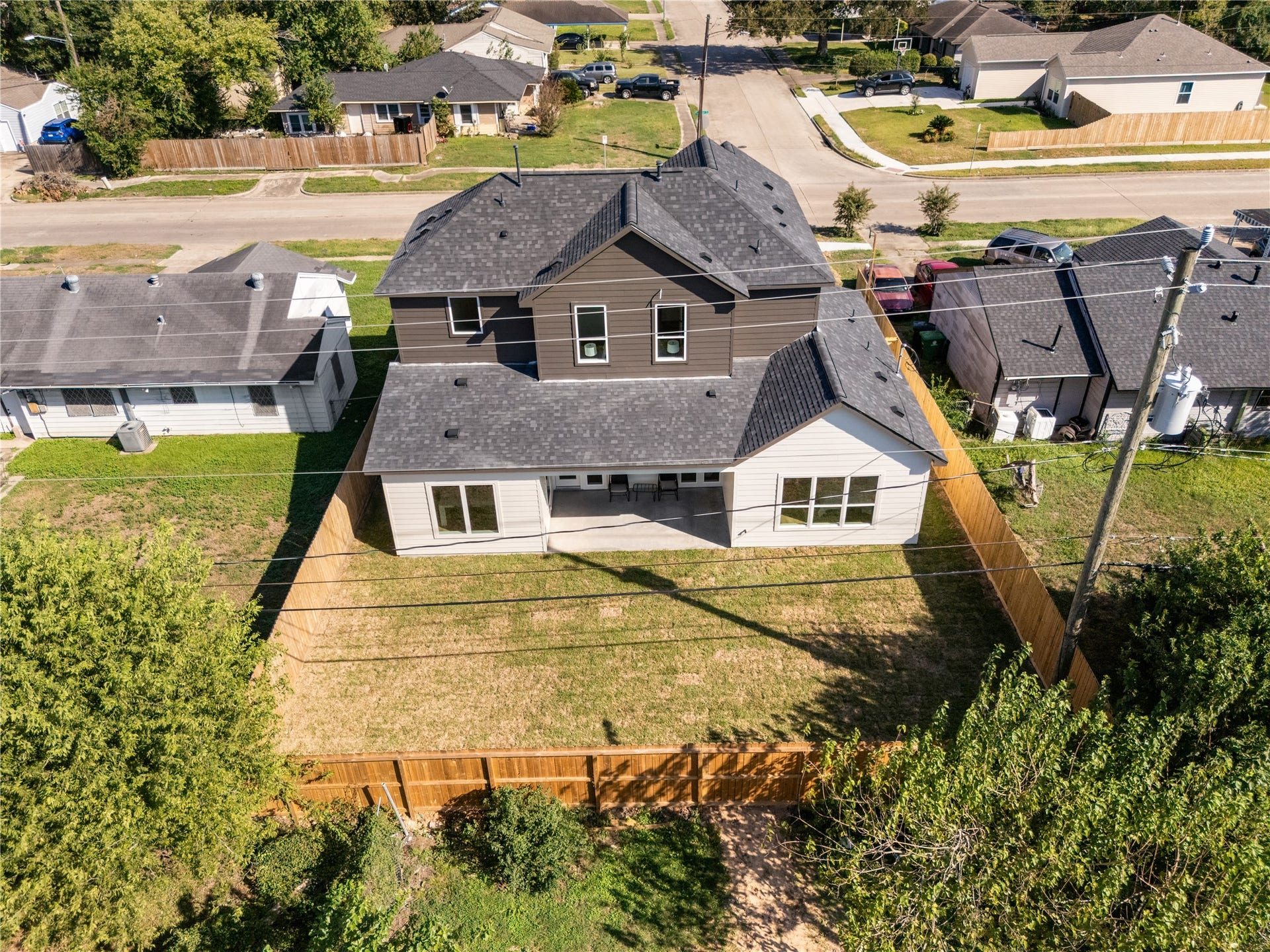 6714 Tierwester Street, Houston, TX 77021 An elevated perspective showcases the home's generous backyard, complete with a covered patio and fully fenced lawn.