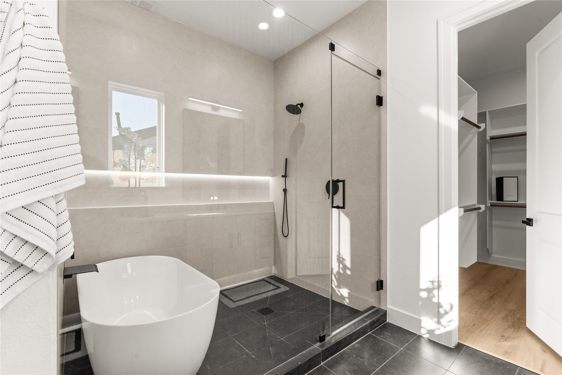 6714 Tierwester Street, Houston, TX 77021 The primary ensuite balances contemporary design with spa-inspired comfort, featuring a freestanding soaking tub, an expansive glass-enclosed shower, and large-format tile.